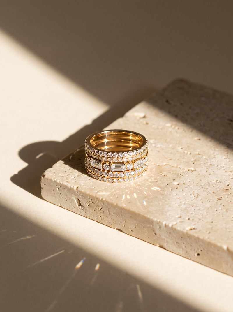 Stack of three lab-grown diamond wedding bands in yellow gold