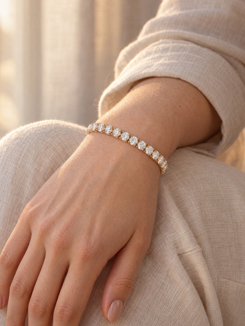 Woman wearing a lab-grown diamond tennis bracelet in yellow gold