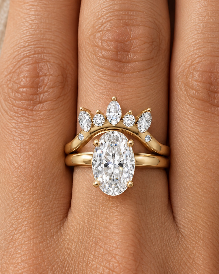 Oval lab-grown diamond engagement ring with a curved crown band on the hand