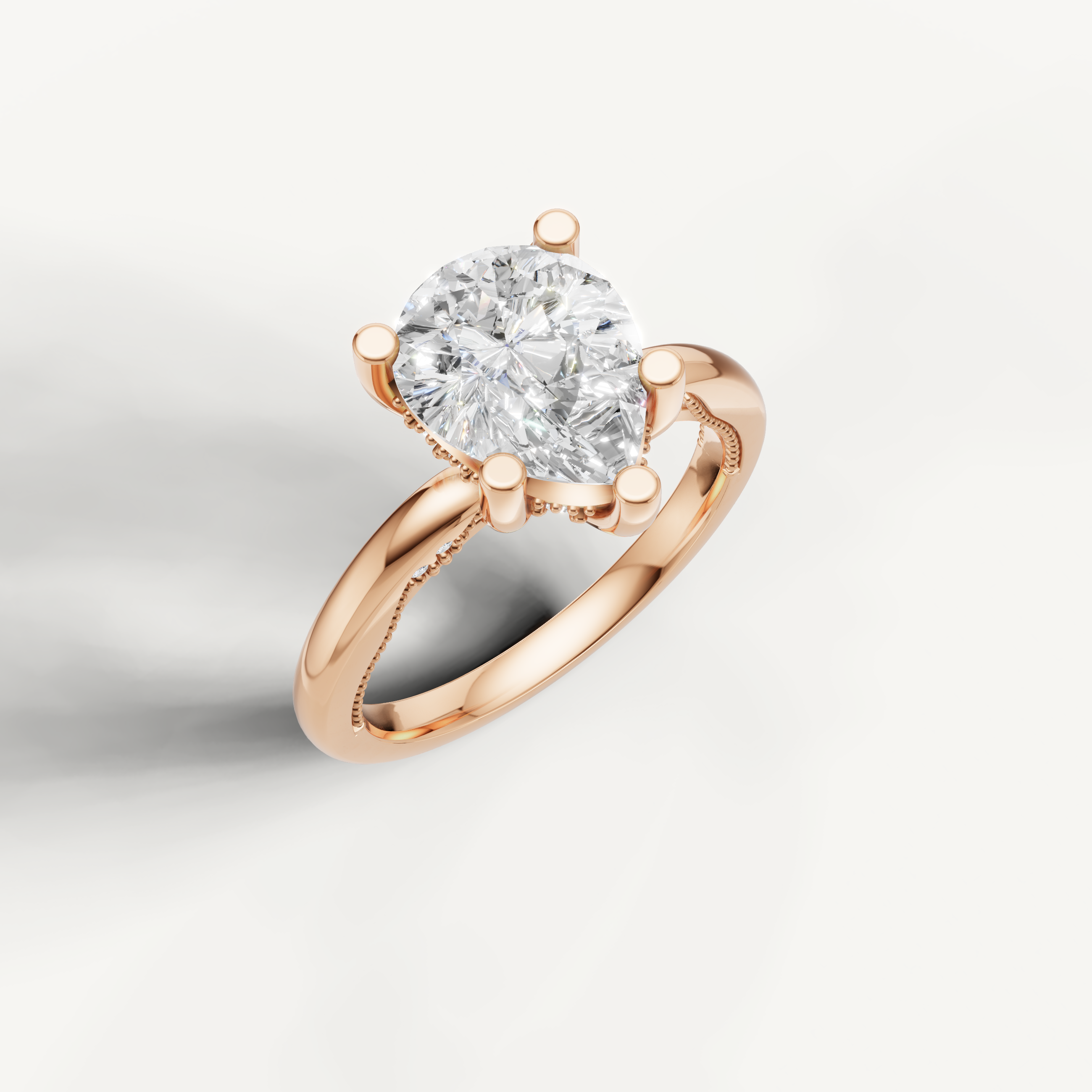 A soft rose gold solitaire ring highlighting the elegant, tapered shape of a pear-cut center stone.