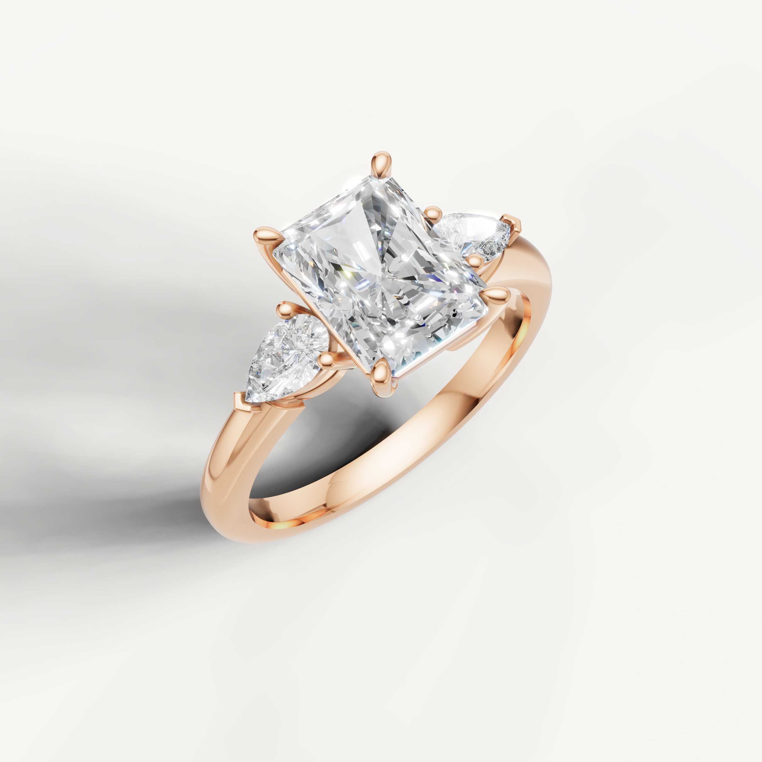 romantic radiant cut lab grown diamond trilogy ring with pear accent diamonds