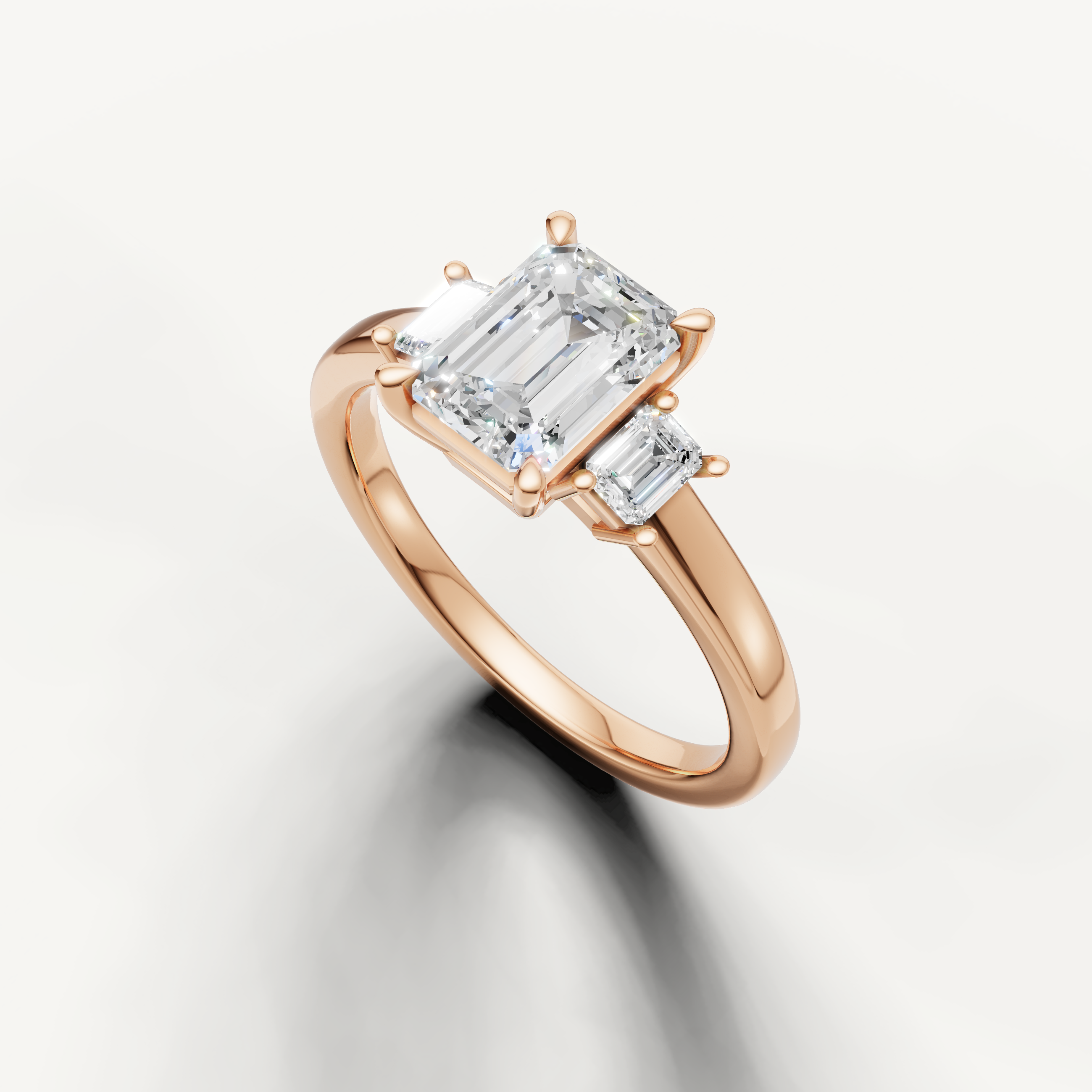 14K rose gold emerald cut lab grown diamond ring with baguette side diamonds and polished band