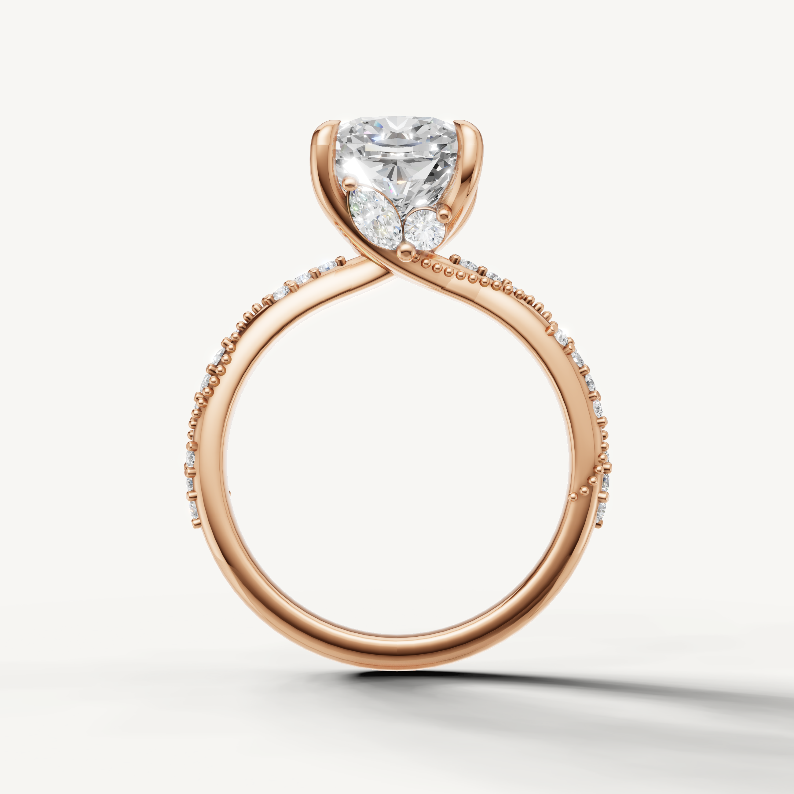 Rose gold cushion cut solitaire engagement ring with modern twisted pavé design by Raul Diamonds