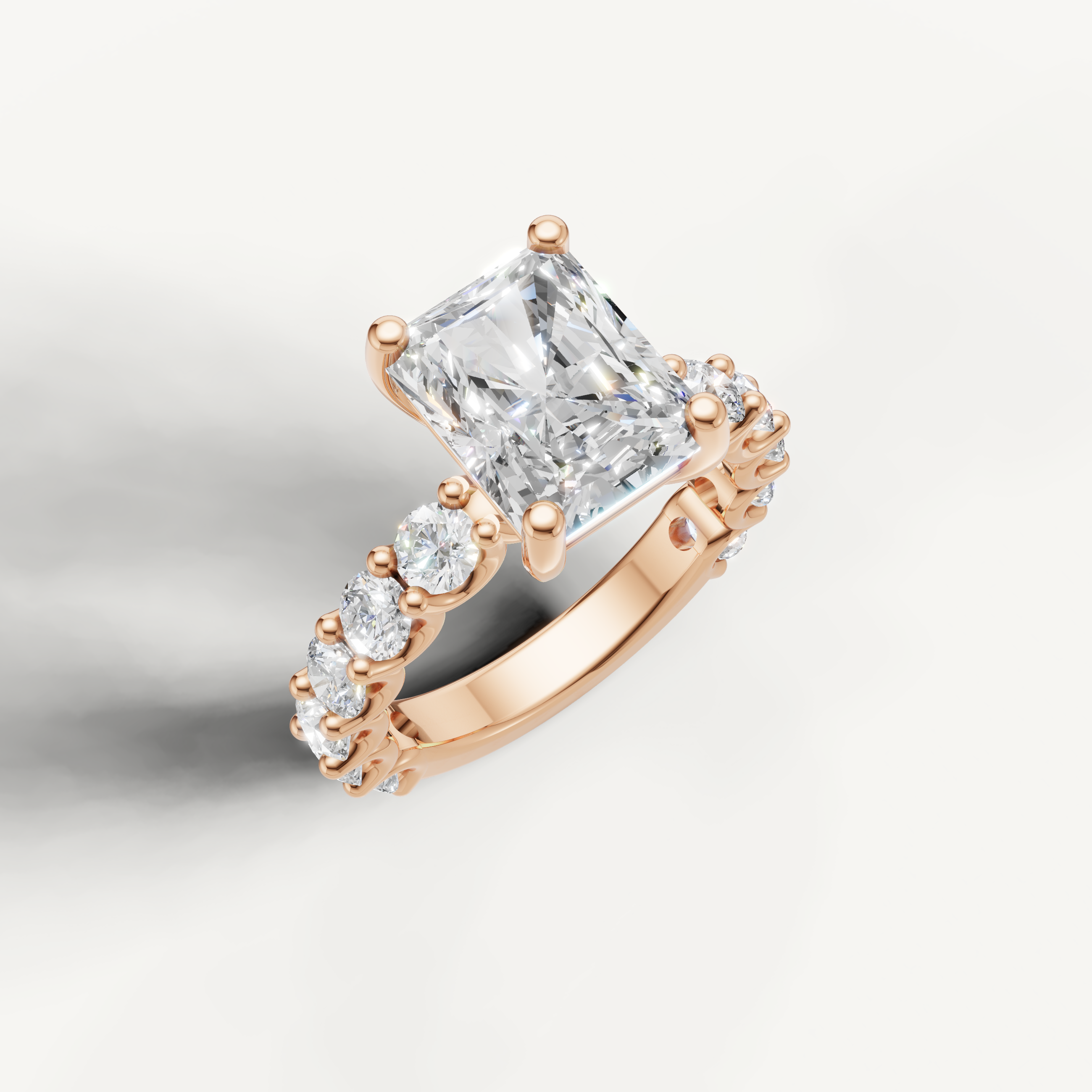 IGI certified radiant cut lab diamond ring profile with round side stones rose gold