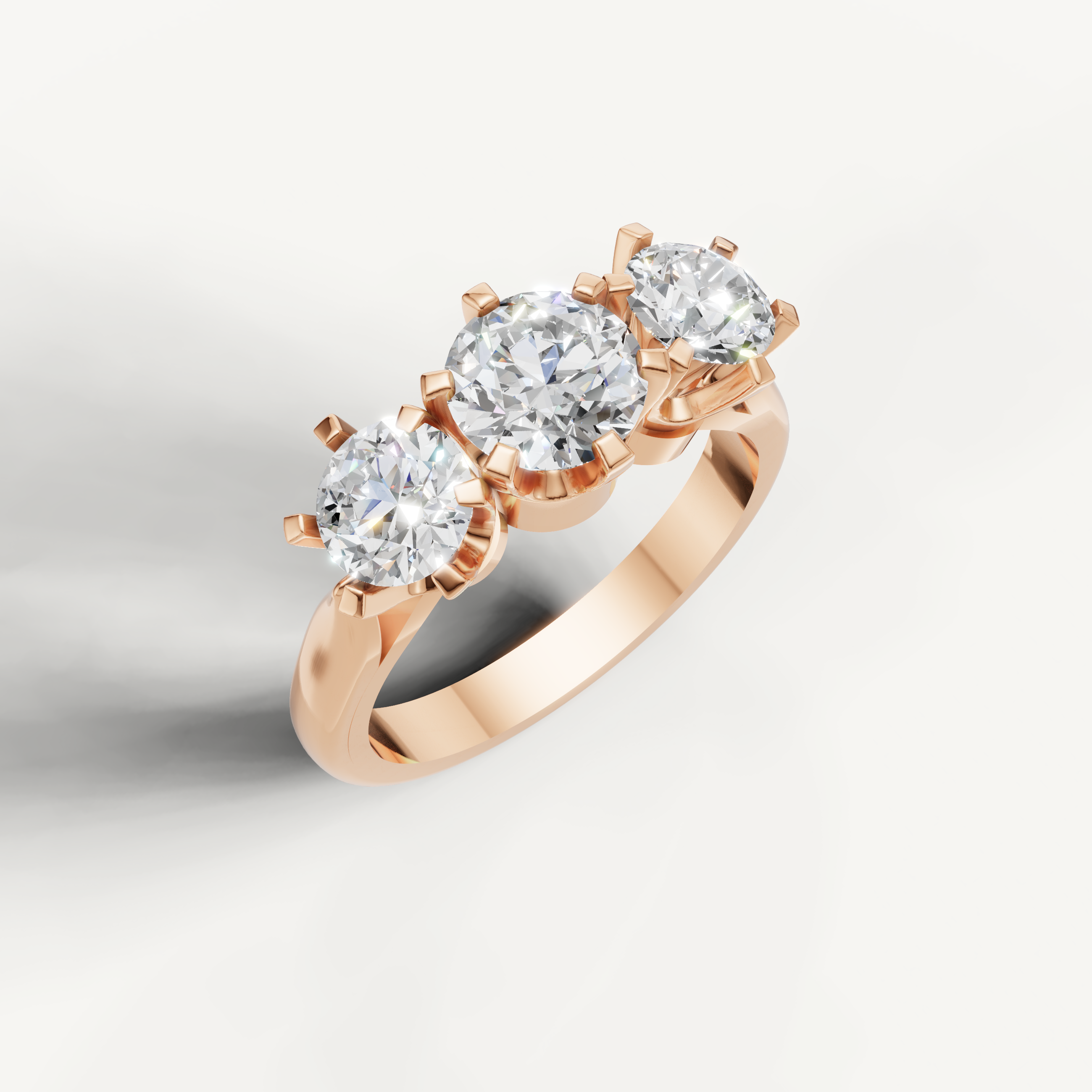 Three stone round cut diamond ring in rose gold by Raul Diamonds