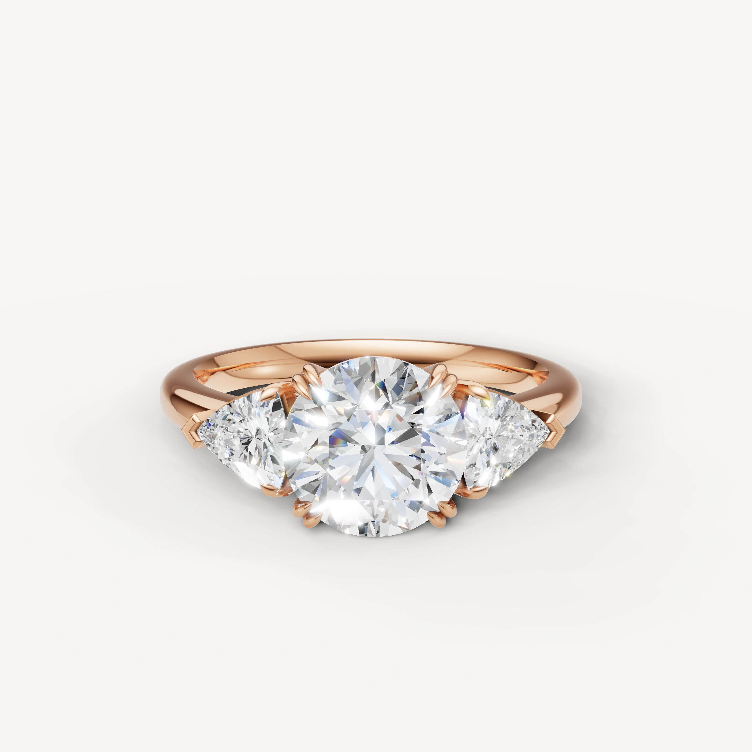 round brilliant lab grown diamond engagement ring with trillion side stones in 14k rose gold