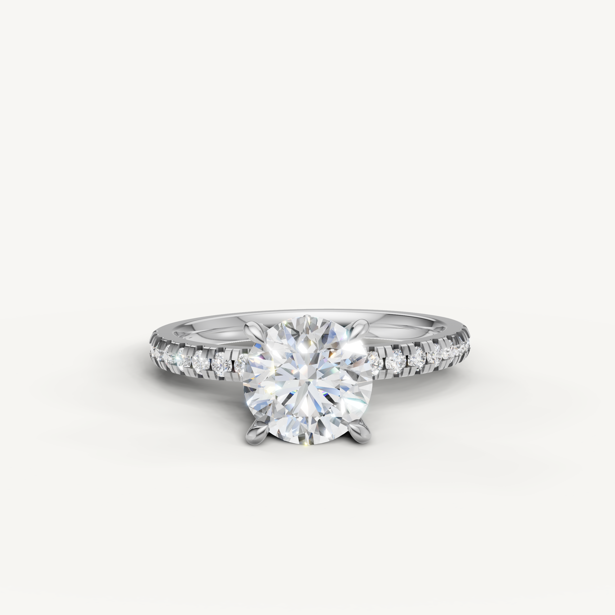 Modern white gold round brilliant cut engagement ring with a seamless pavé band and exceptional clarity.