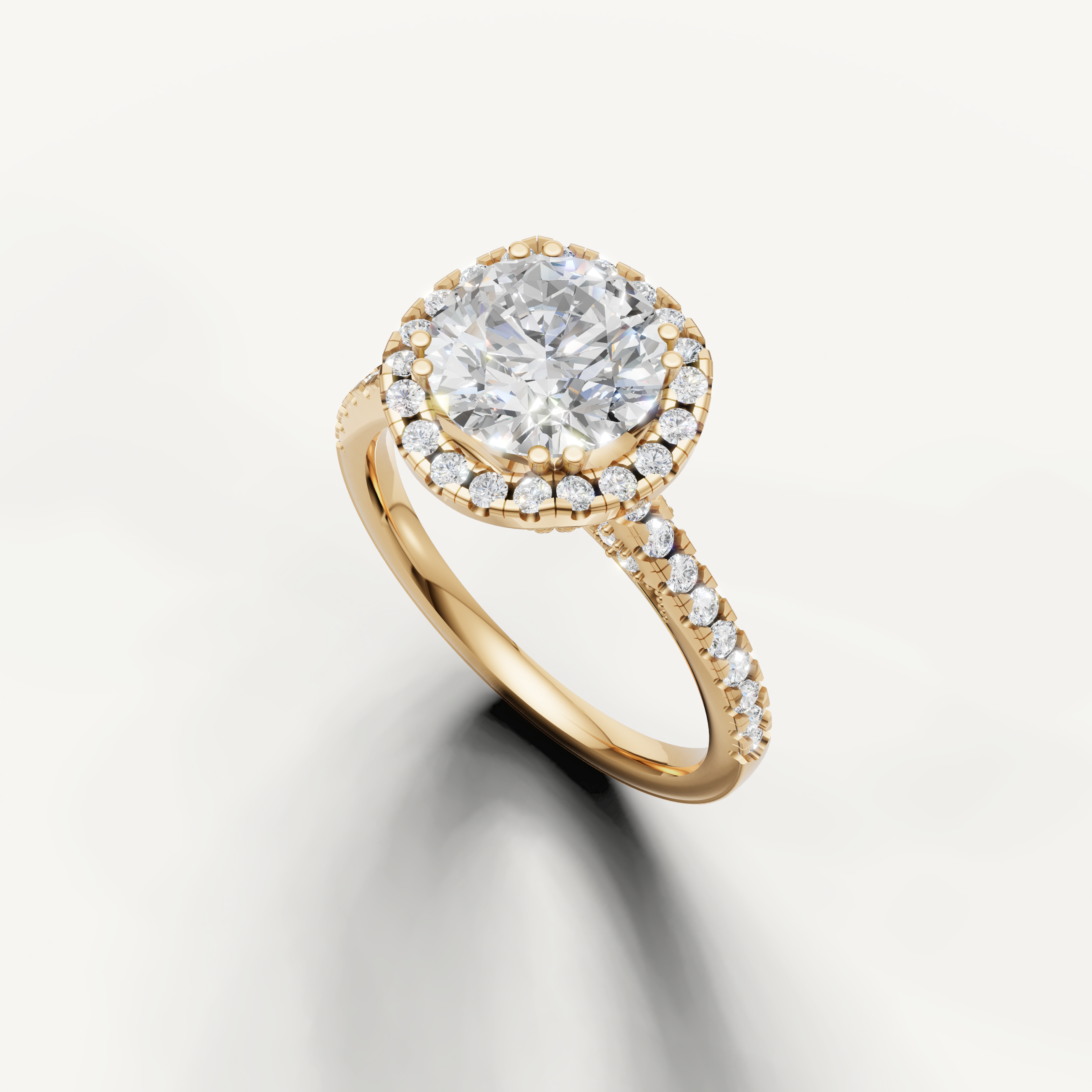 Yellow gold round cut lab grown diamond ring featuring a classic halo setting and delicate pavé band
