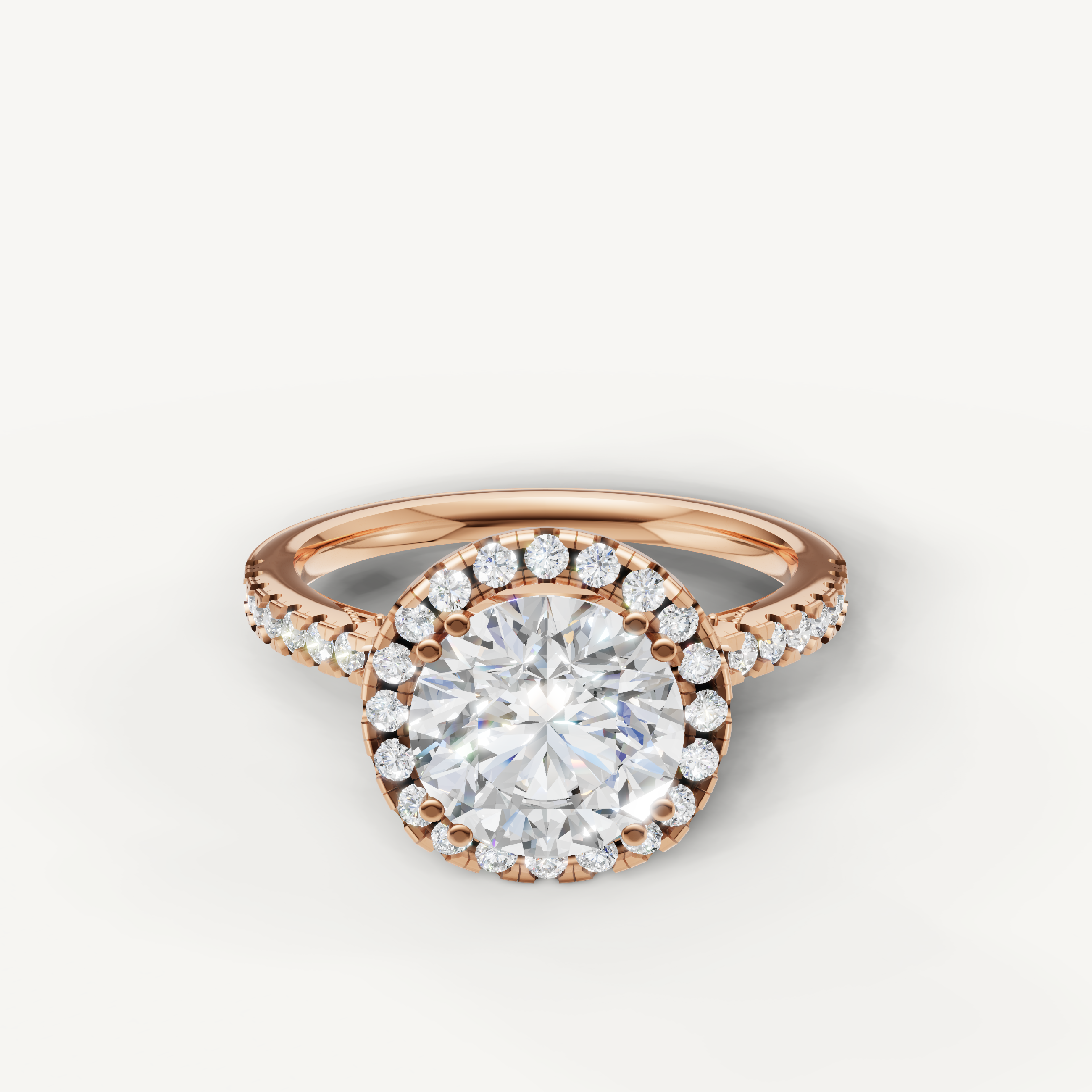 Round cut lab grown diamond halo engagement ring in 14K rose gold with pavé diamond band by Raul Diamonds