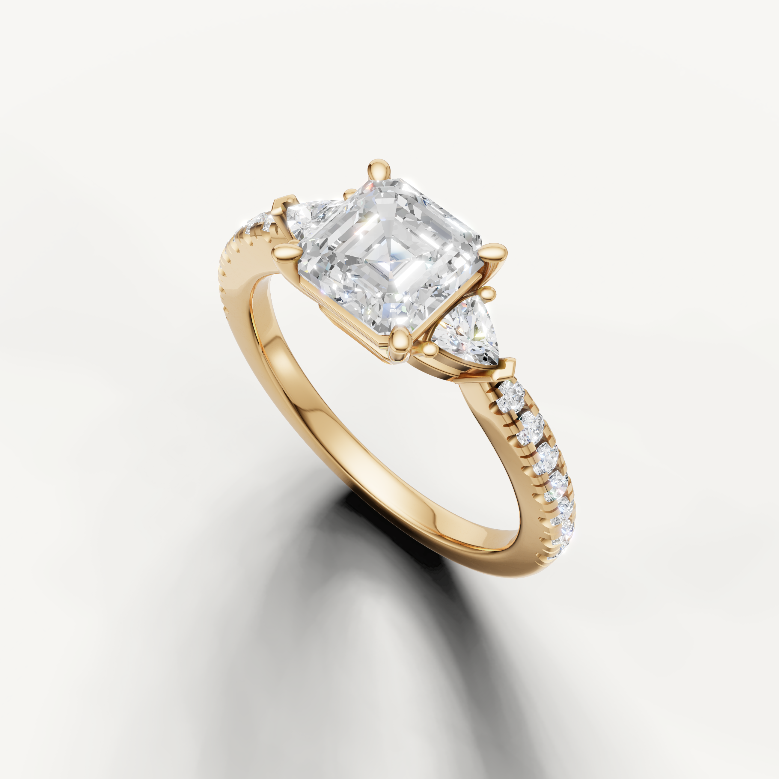 14K yellow gold Asscher cut diamond ring with pavé band and modern three-stone design