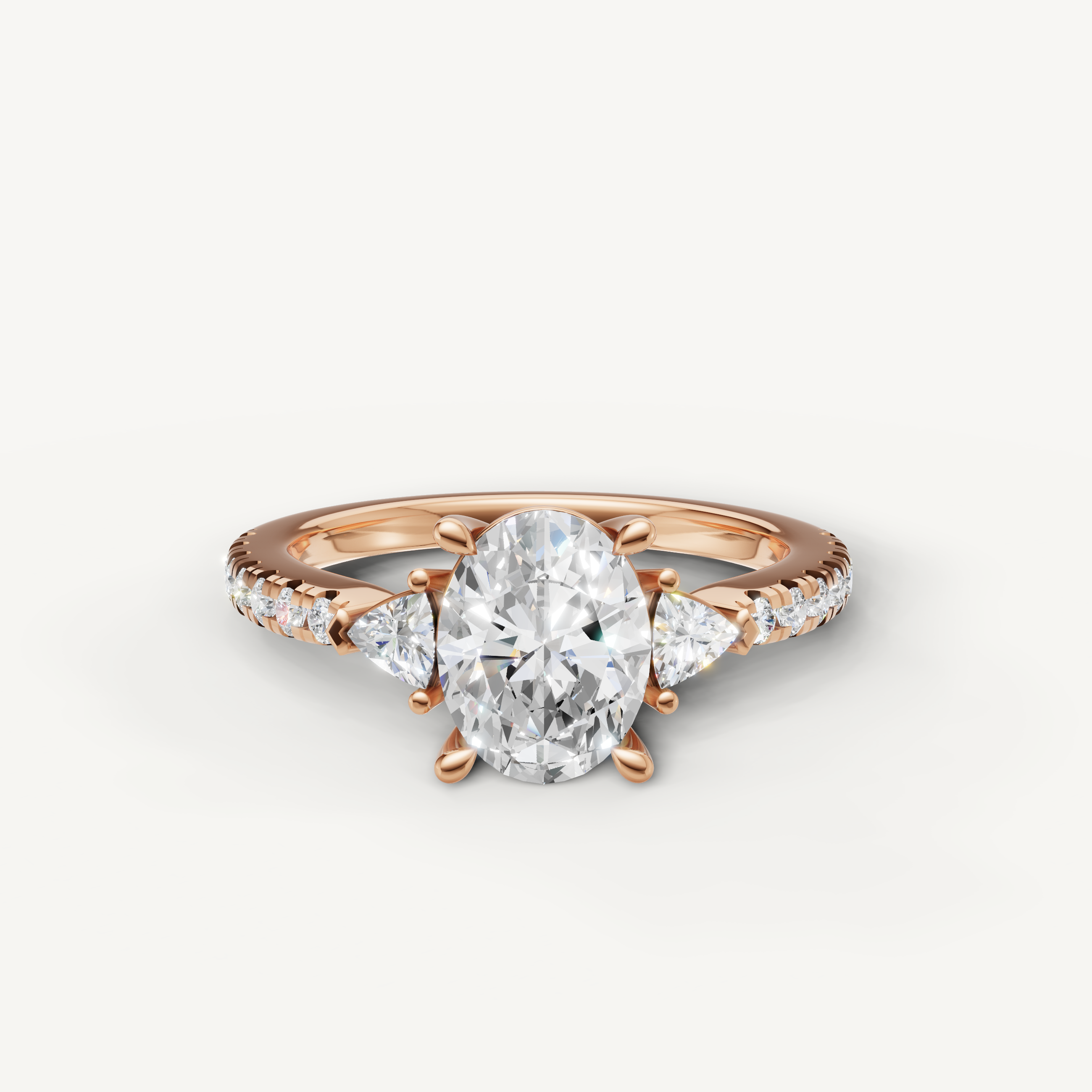 Oval cut lab grown diamond engagement ring in 14K rose gold with three stone design