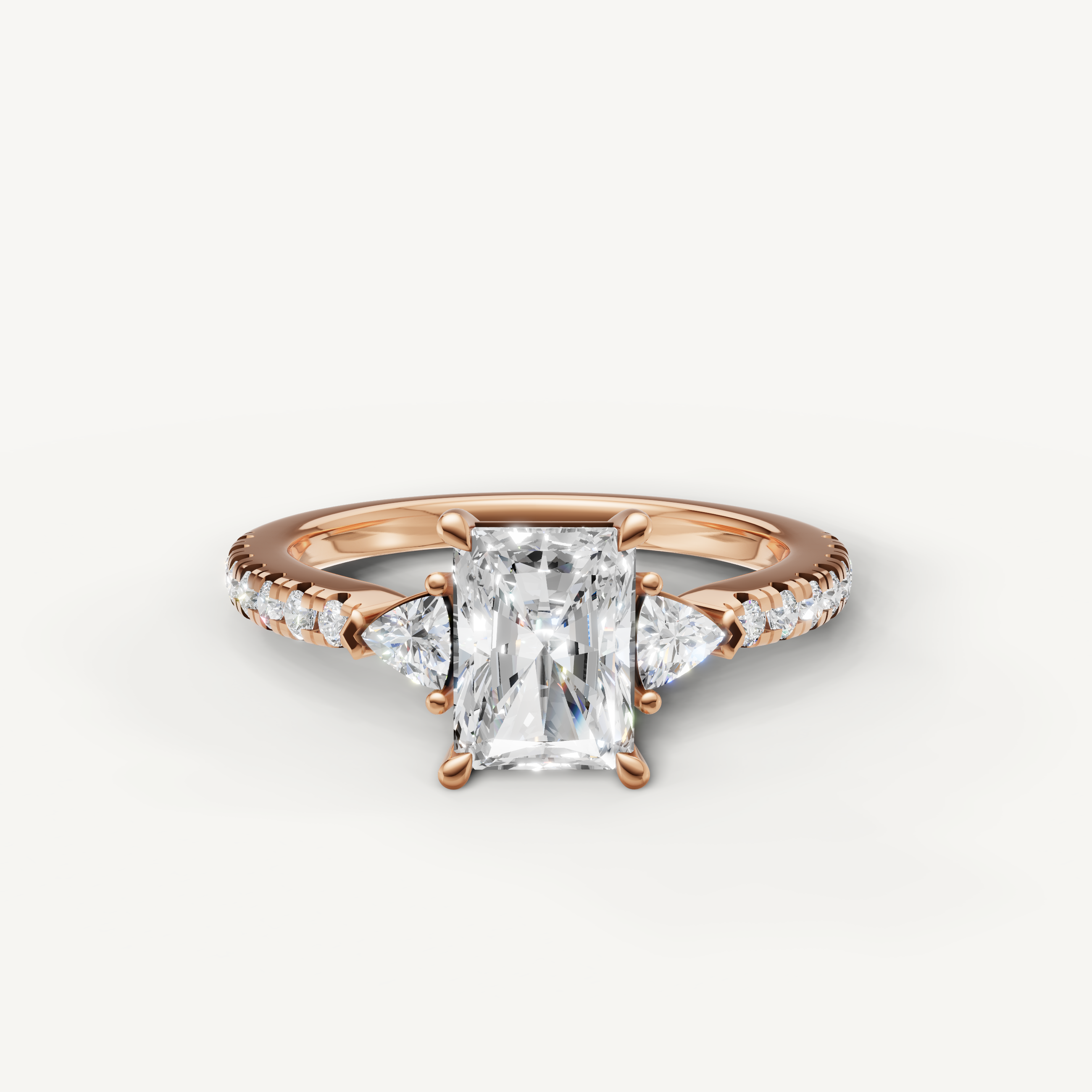 Radiant cut lab grown diamond engagement ring in 14K rose gold with pavé band and side stones