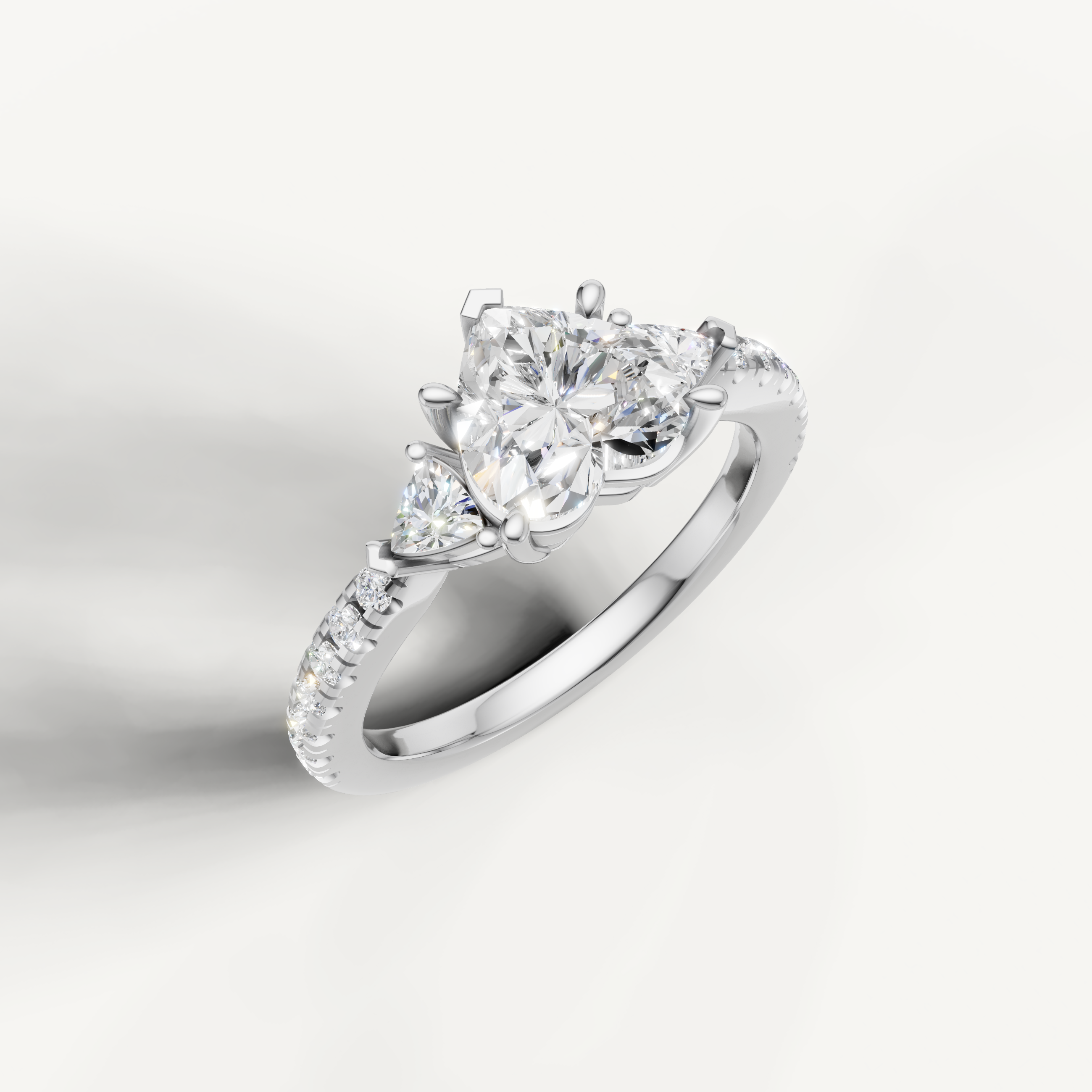 Three-stone heart cut lab grown diamond ring with pavé band in 14K gold