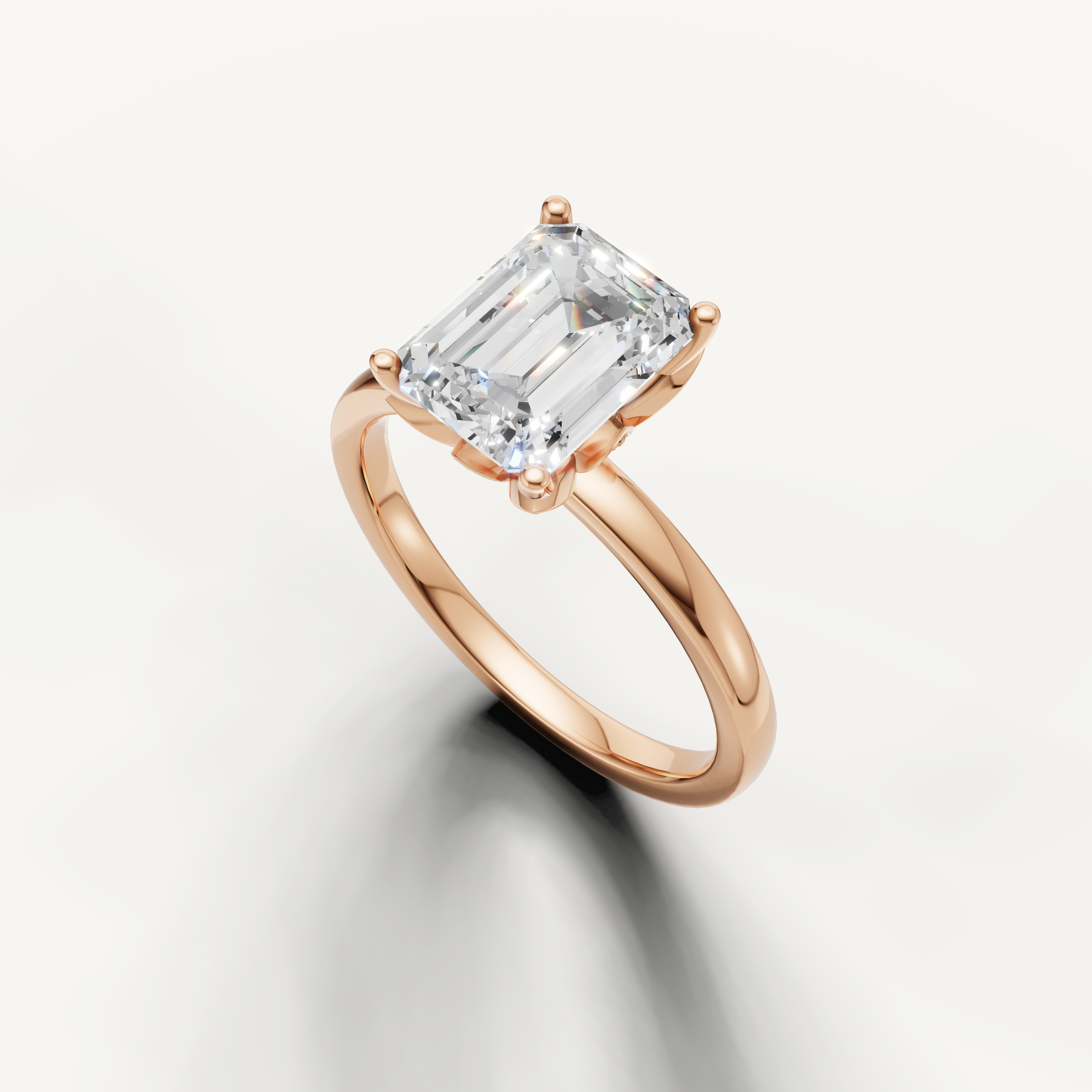 Elegant emerald cut solitaire ring with classic 4 prong setting rose gold