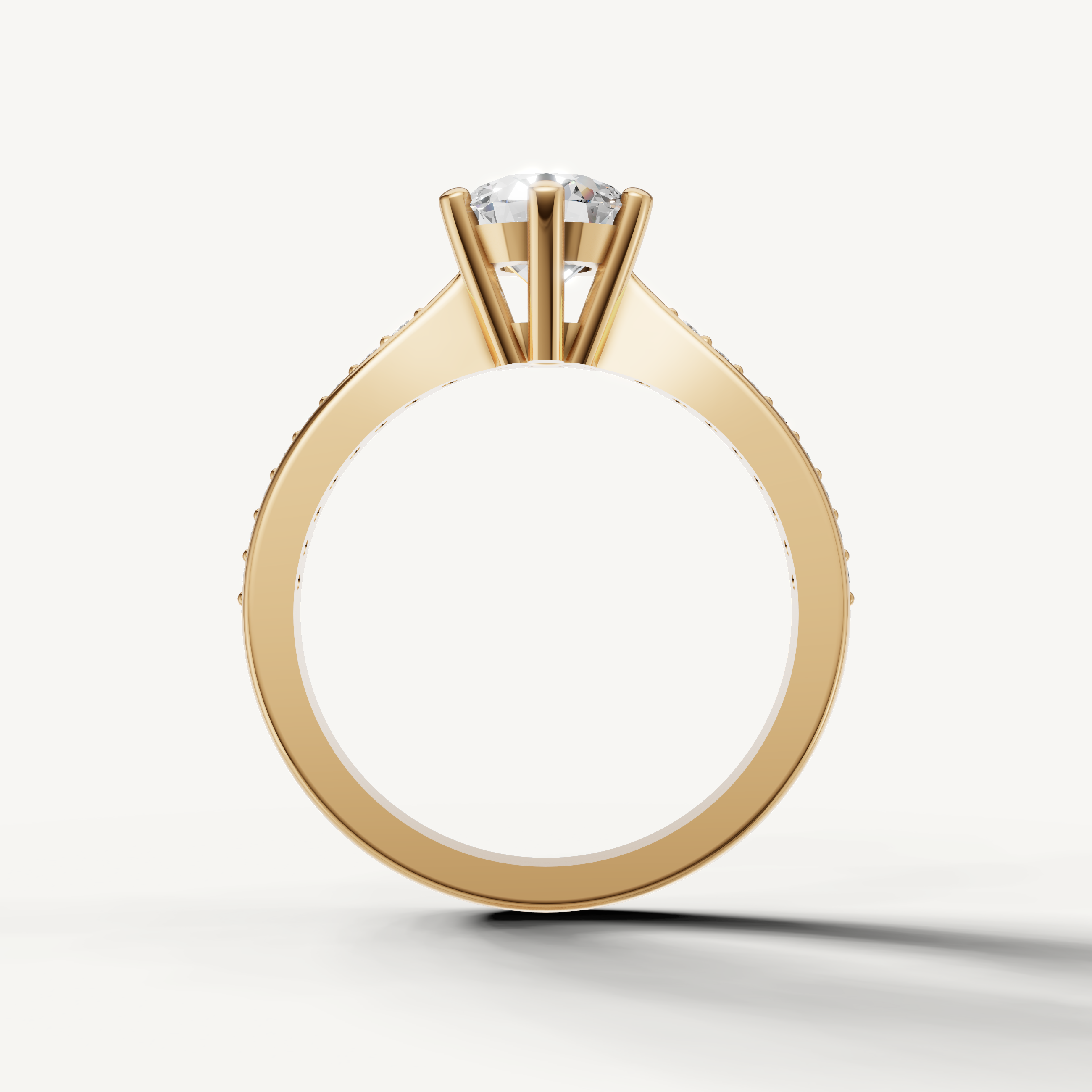 Elegant yellow gold round solitaire ring with slim pavé band by Raul Diamonds