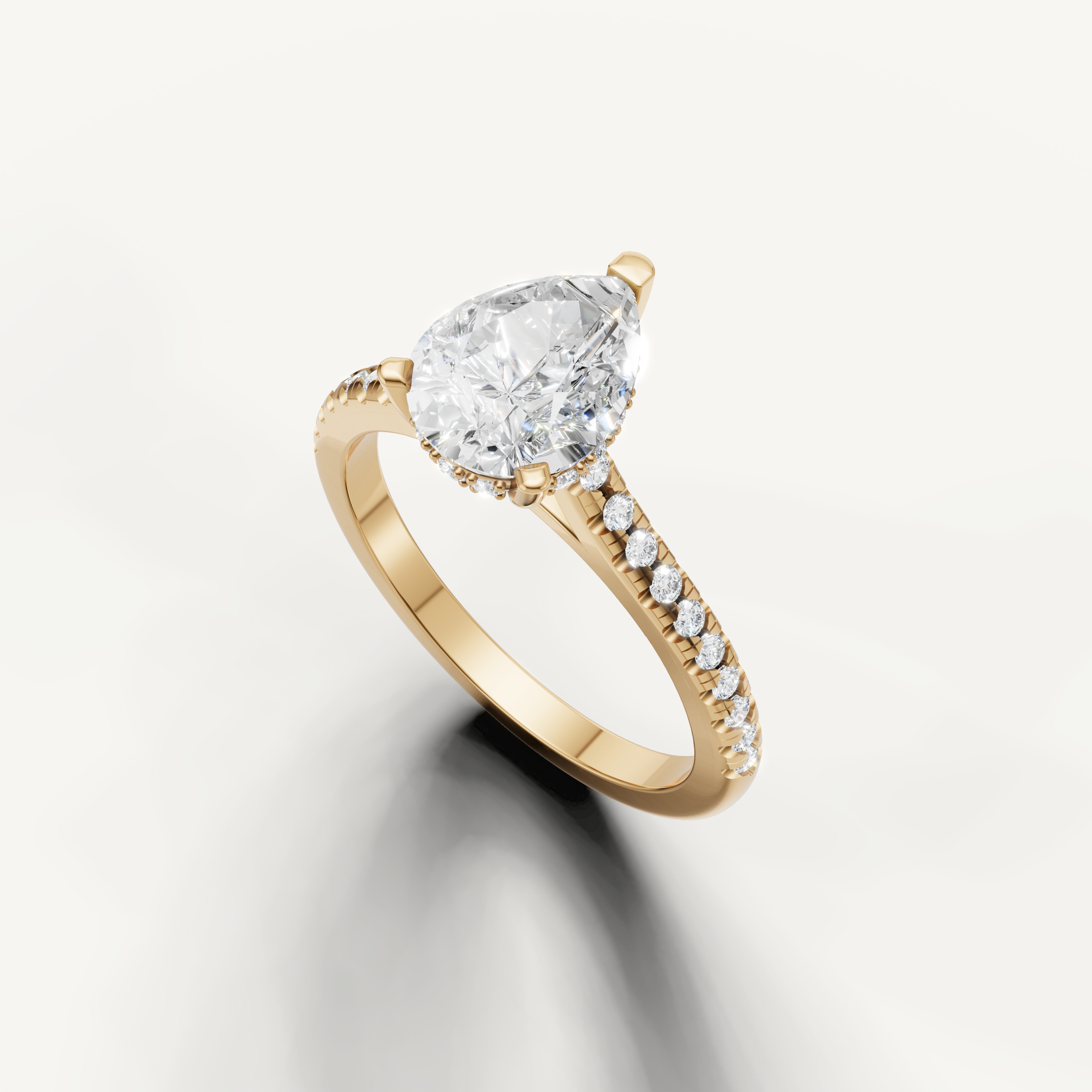 14K yellow gold pear diamond engagement ring featuring a delicate pavé setting by Raul Diamonds