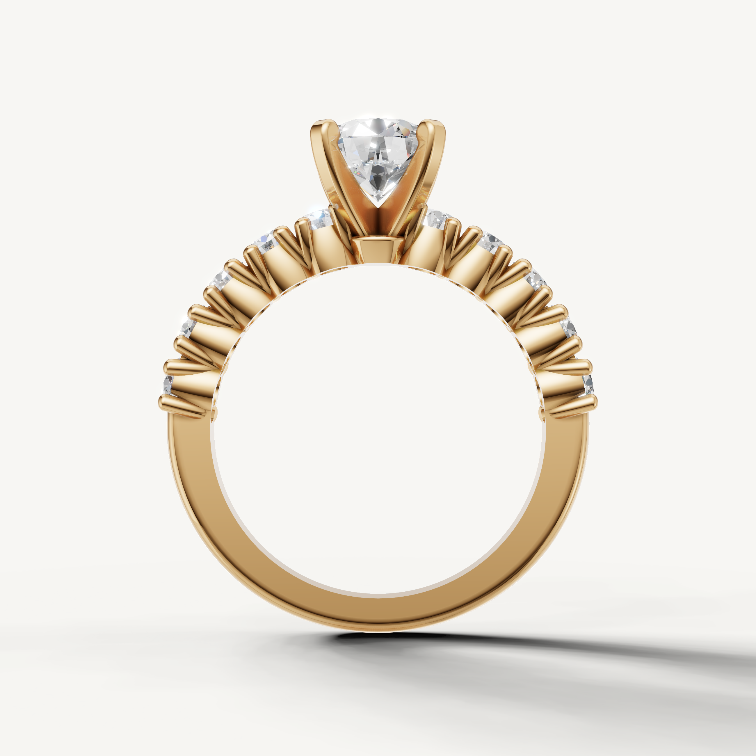 Elegant yellow gold round solitaire ring with accent diamonds by Raul Diamonds