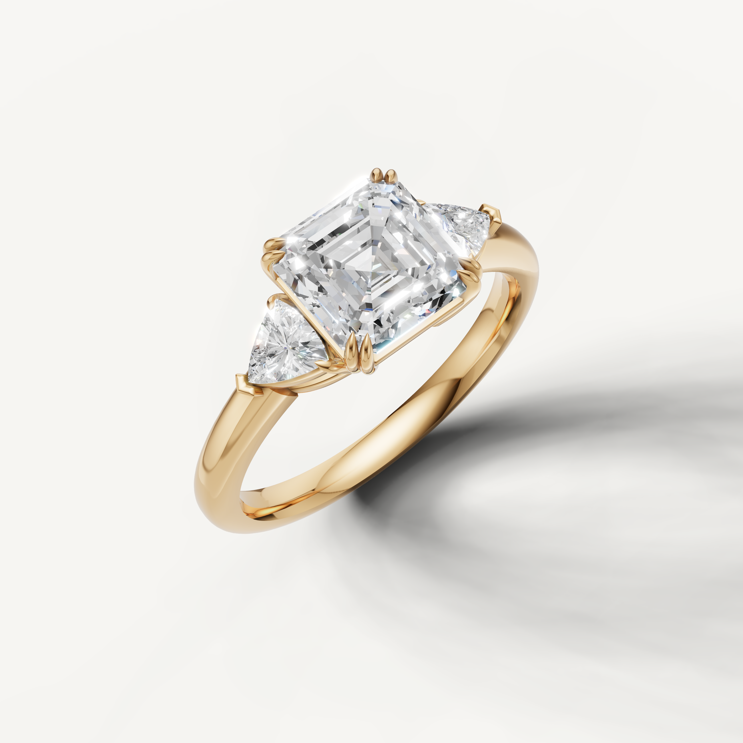 IGI certified asscher cut lab diamond ring with tapered trillion shaped side diamonds in yellow gold