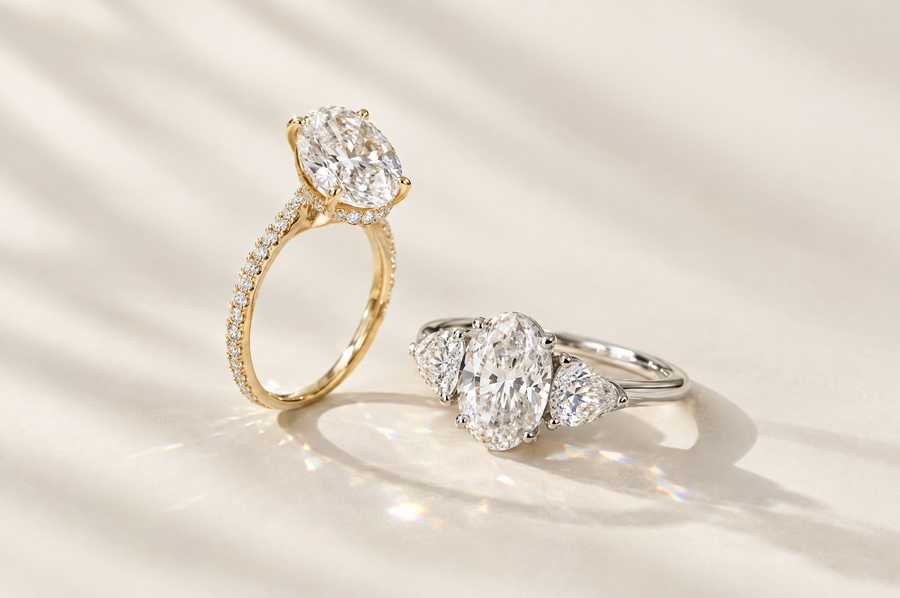 Two oval lab-grown diamond engagement rings in yellow and white gold