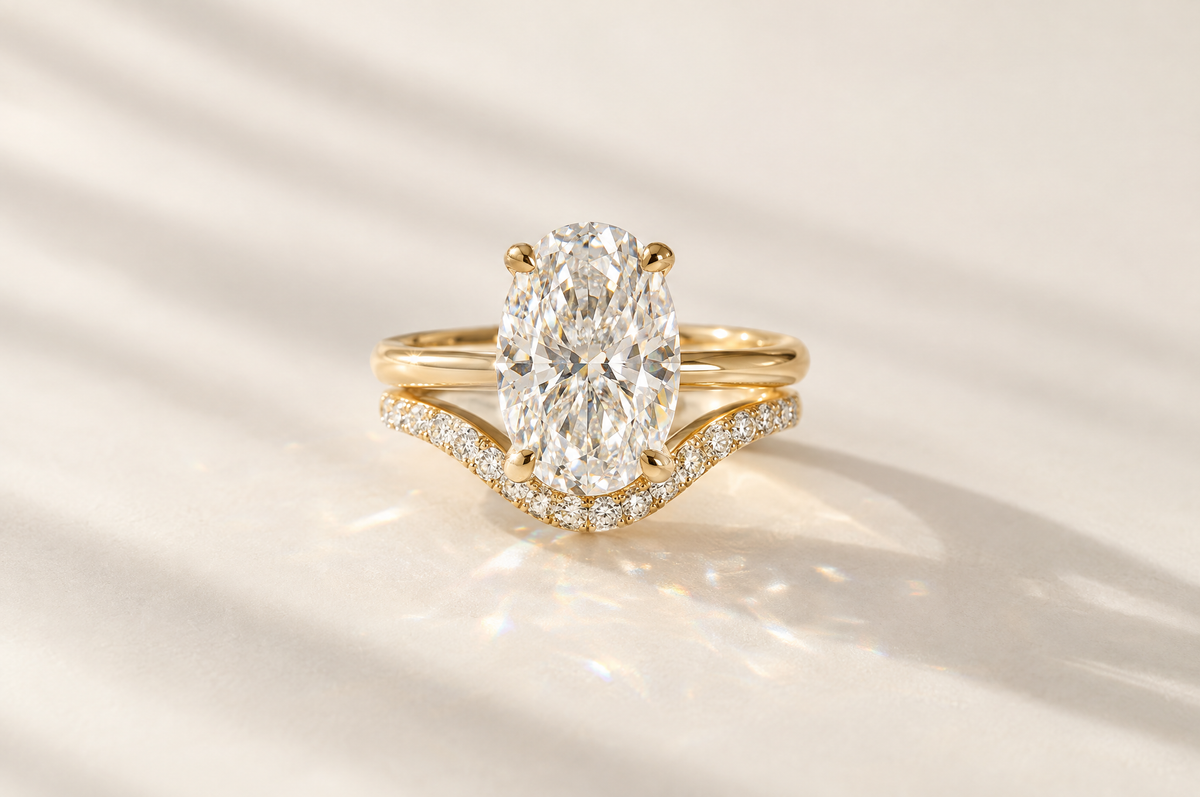 Oval engagement ring with a matching curved diamond wedding band