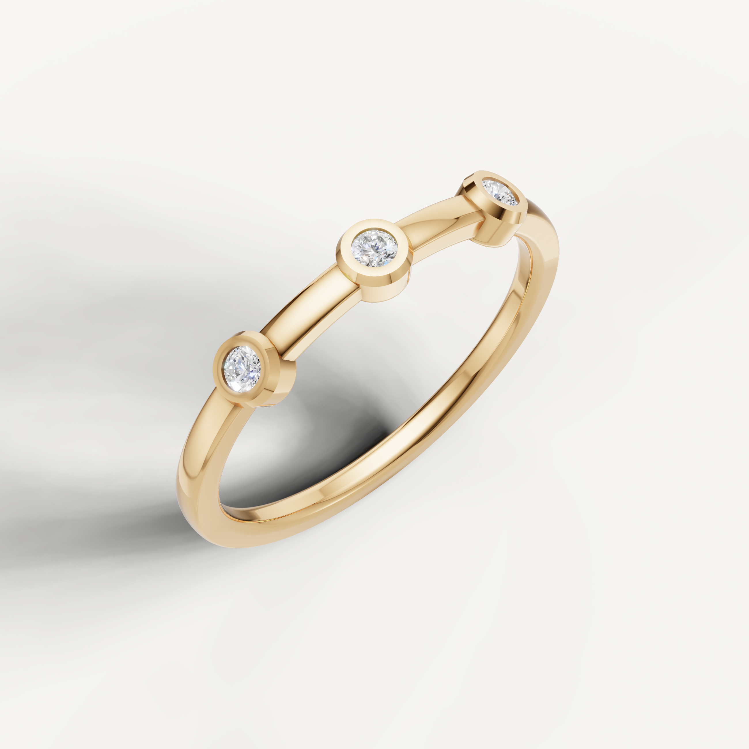 Elegant yellow gold three stone diamond wedding ring with bezel setting