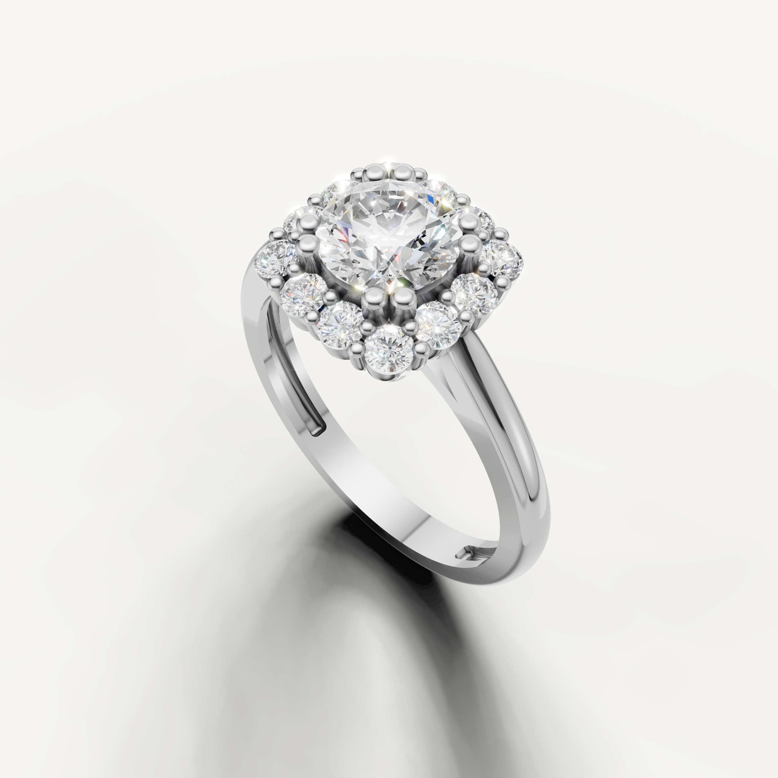 Raul Diamonds classic round halo ring in white gold with sparkling side diamonds.