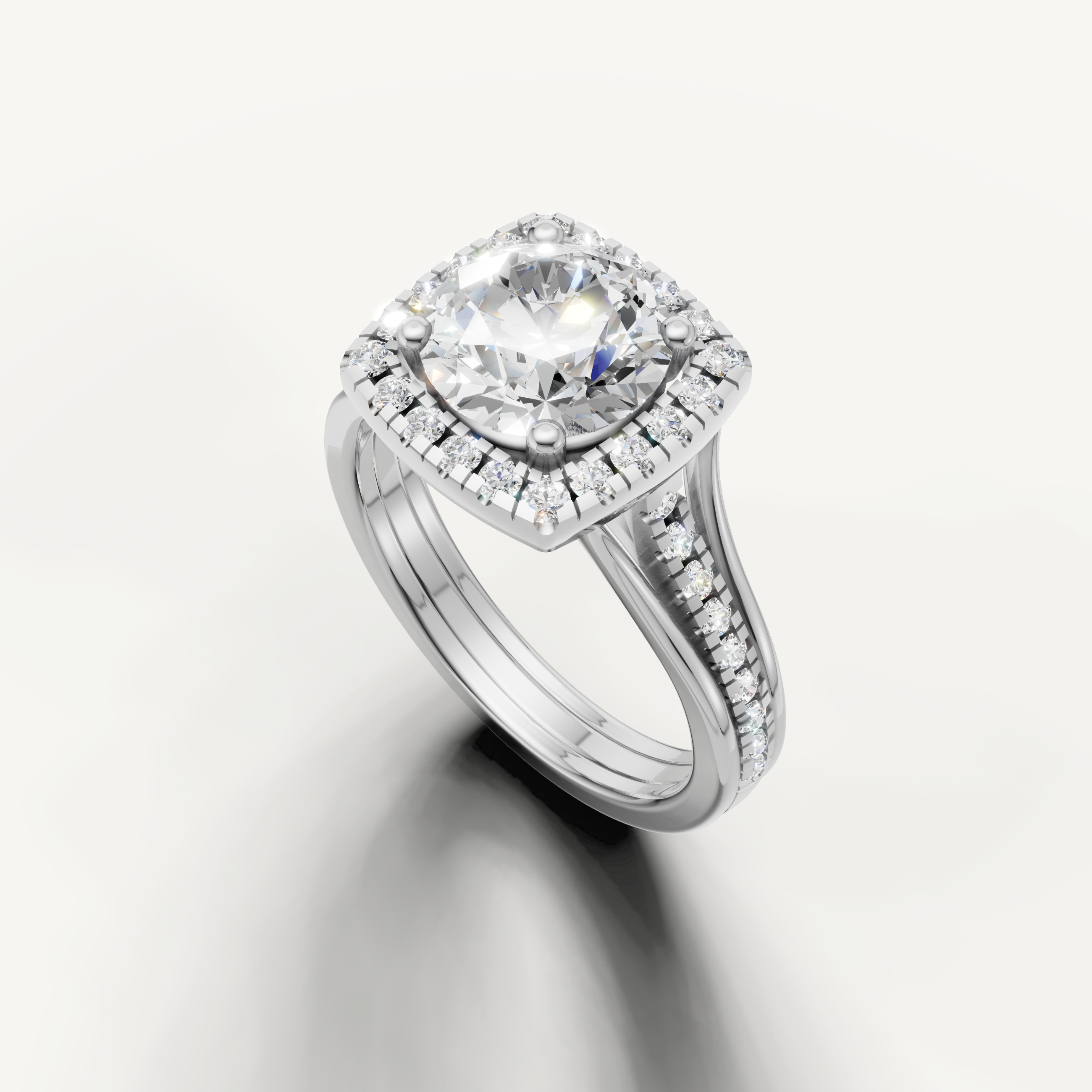 Raul Diamonds classic round halo ring in white gold with split shank band.