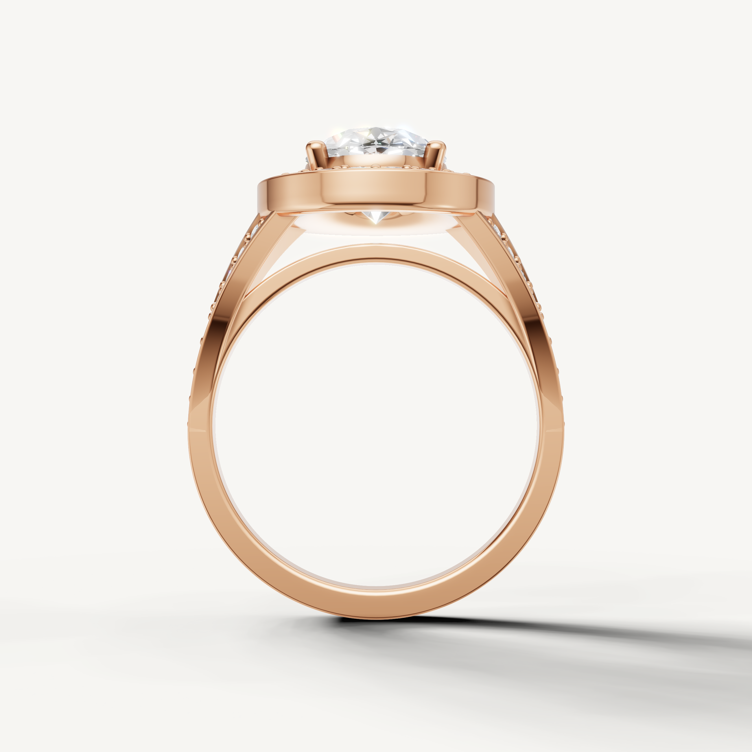 Rose gold oval halo ring with split shank pavé band by Raul Diamonds.