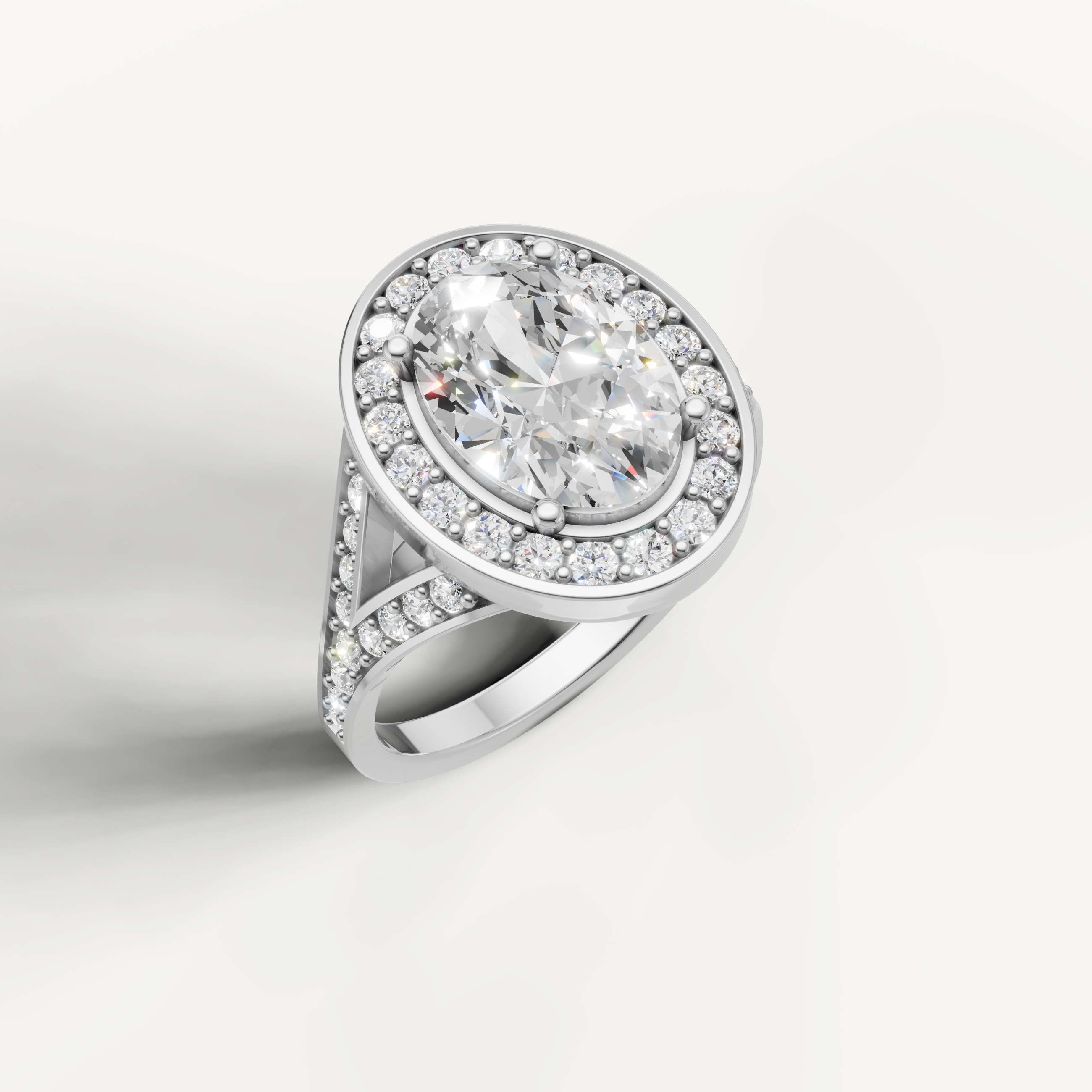 White gold oval cut diamond ring with classic halo setting by Raul Diamonds.