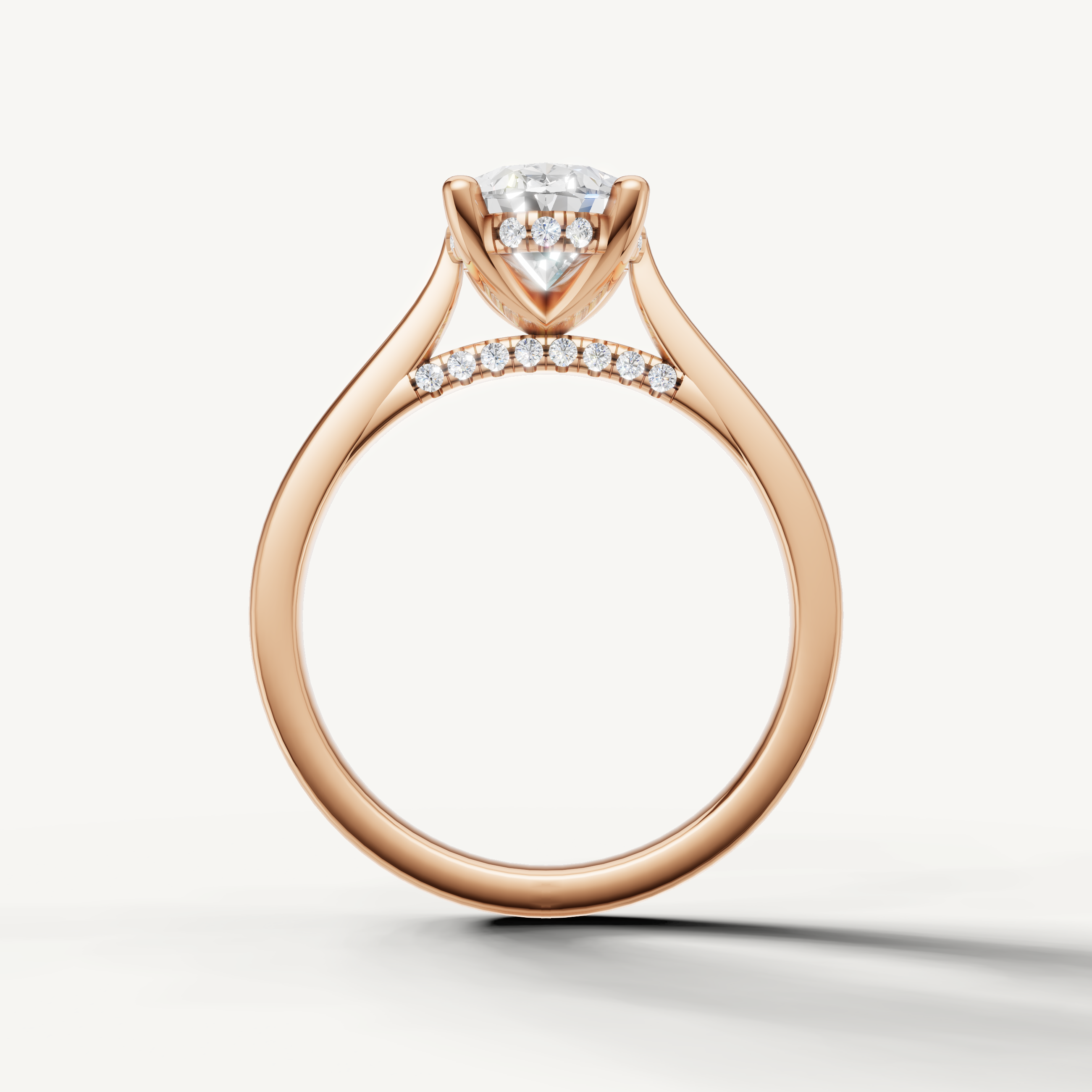 A radiant oval cut diamond ring in rose gold with a hidden diamond-lined bridge by Raul Diamonds