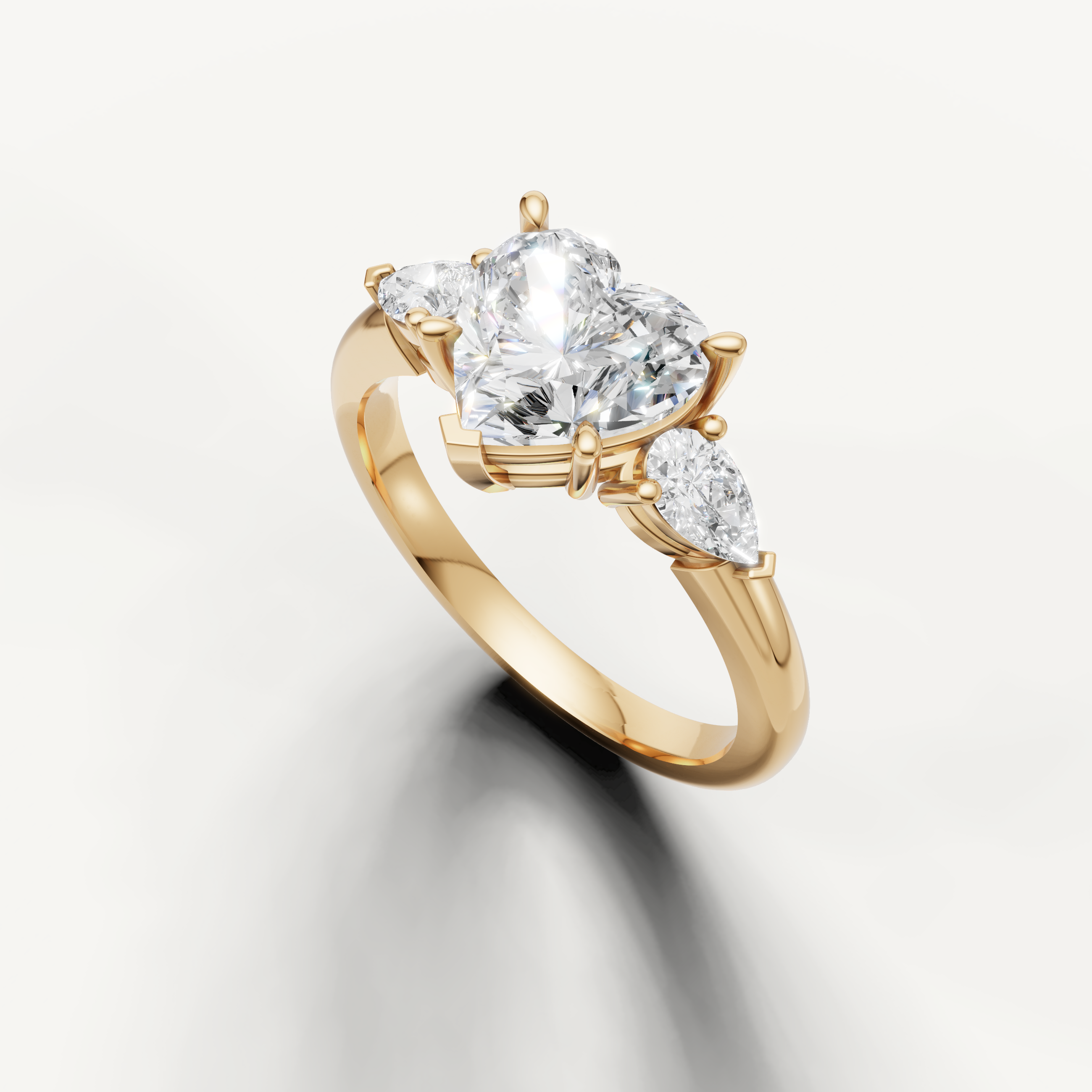 romantic heart diamond ring with pear side stones yellow gold