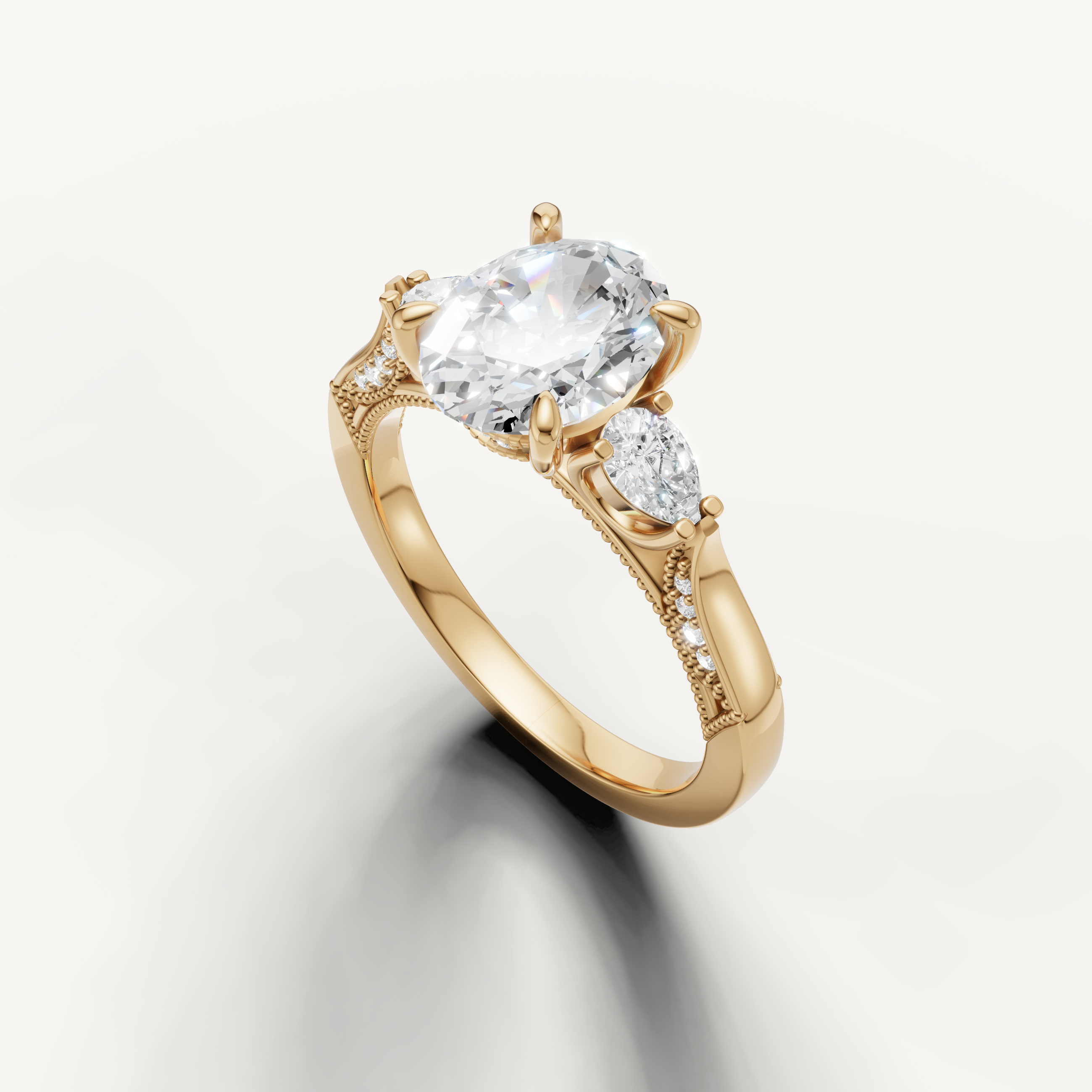 Oval solitaire diamond ring with pear side stones and pavé accents yellow gold