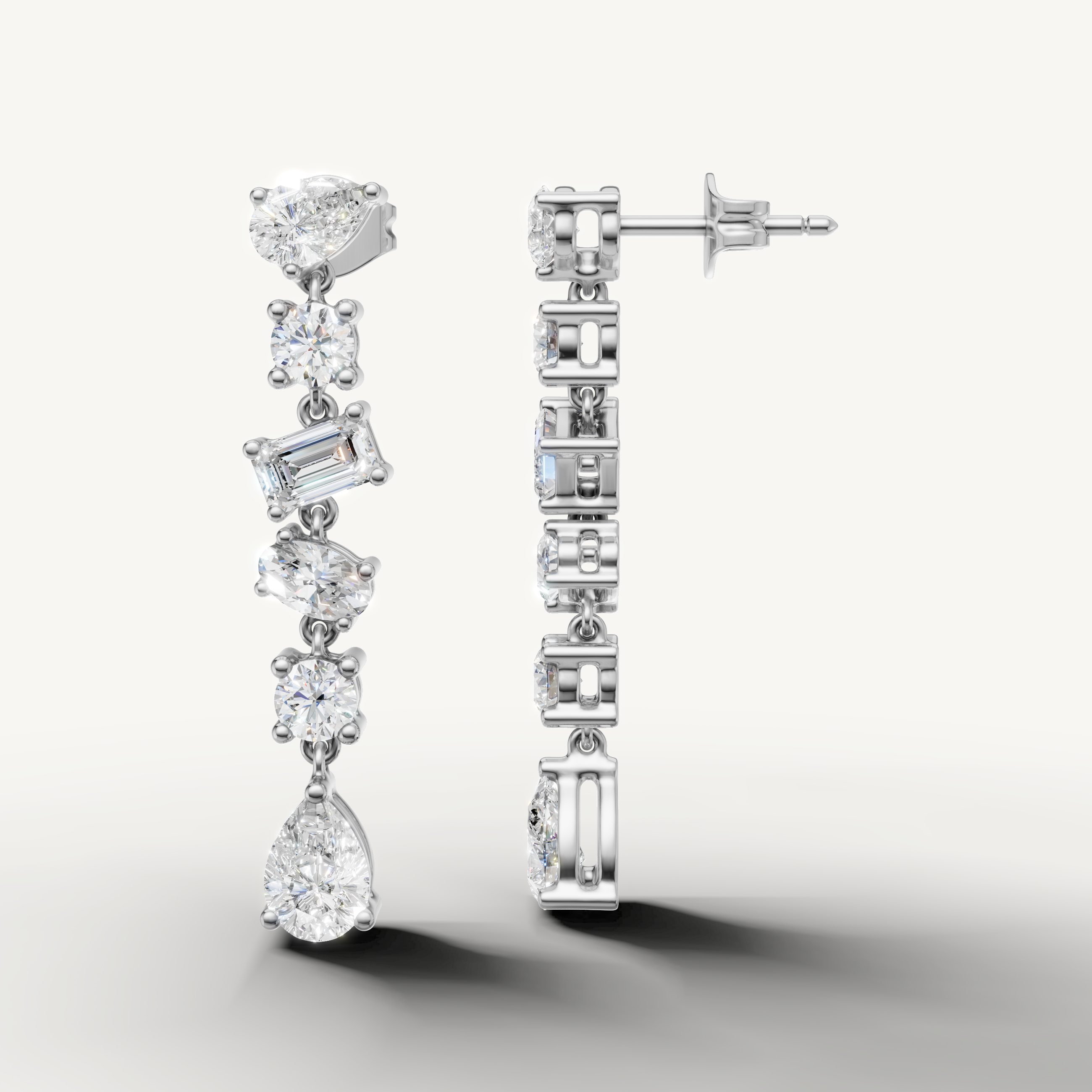 White gold pear and emerald cut diamond dangle earrings by Raul Diamonds