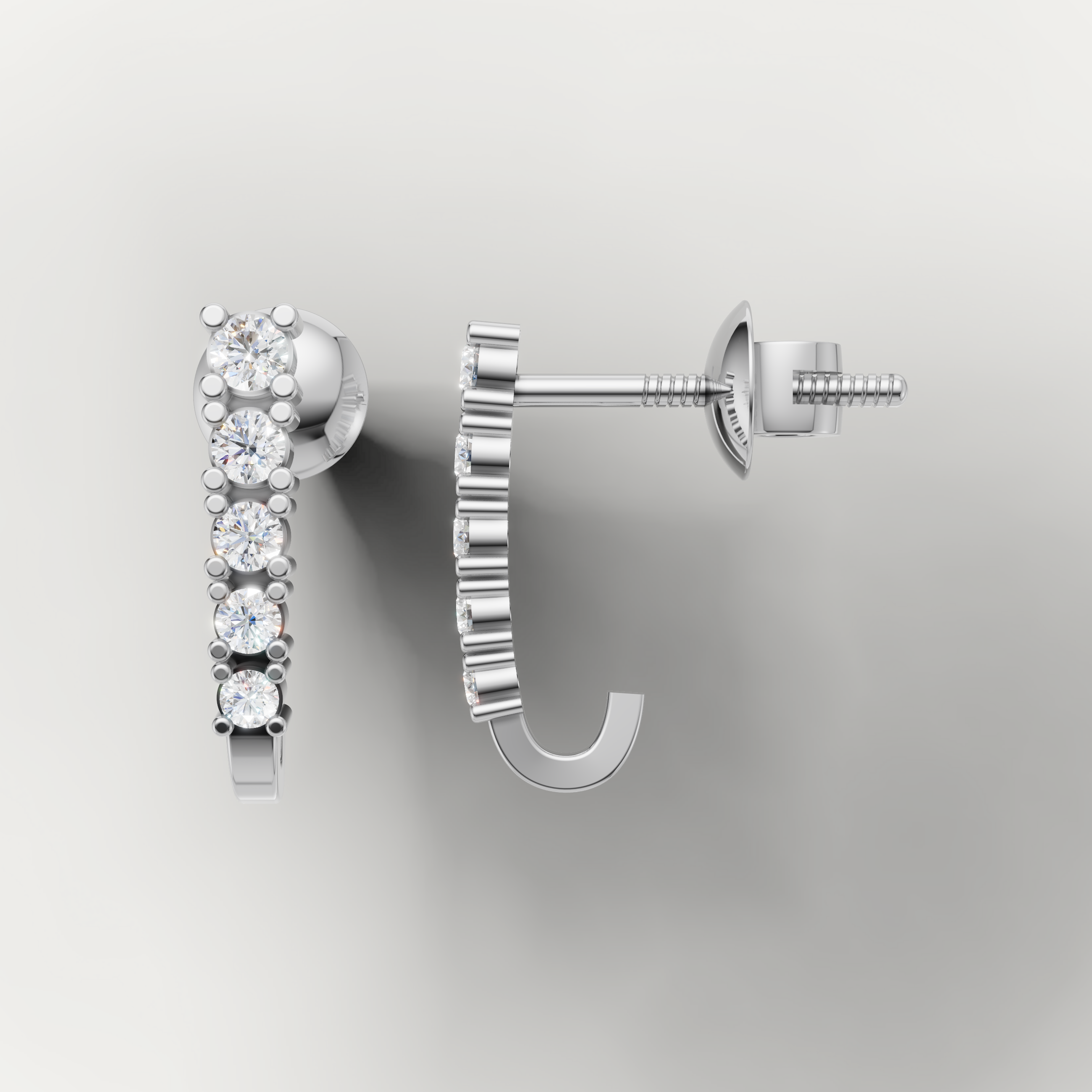 White gold diamond huggie earrings by Raul Diamonds with sleek modern styling