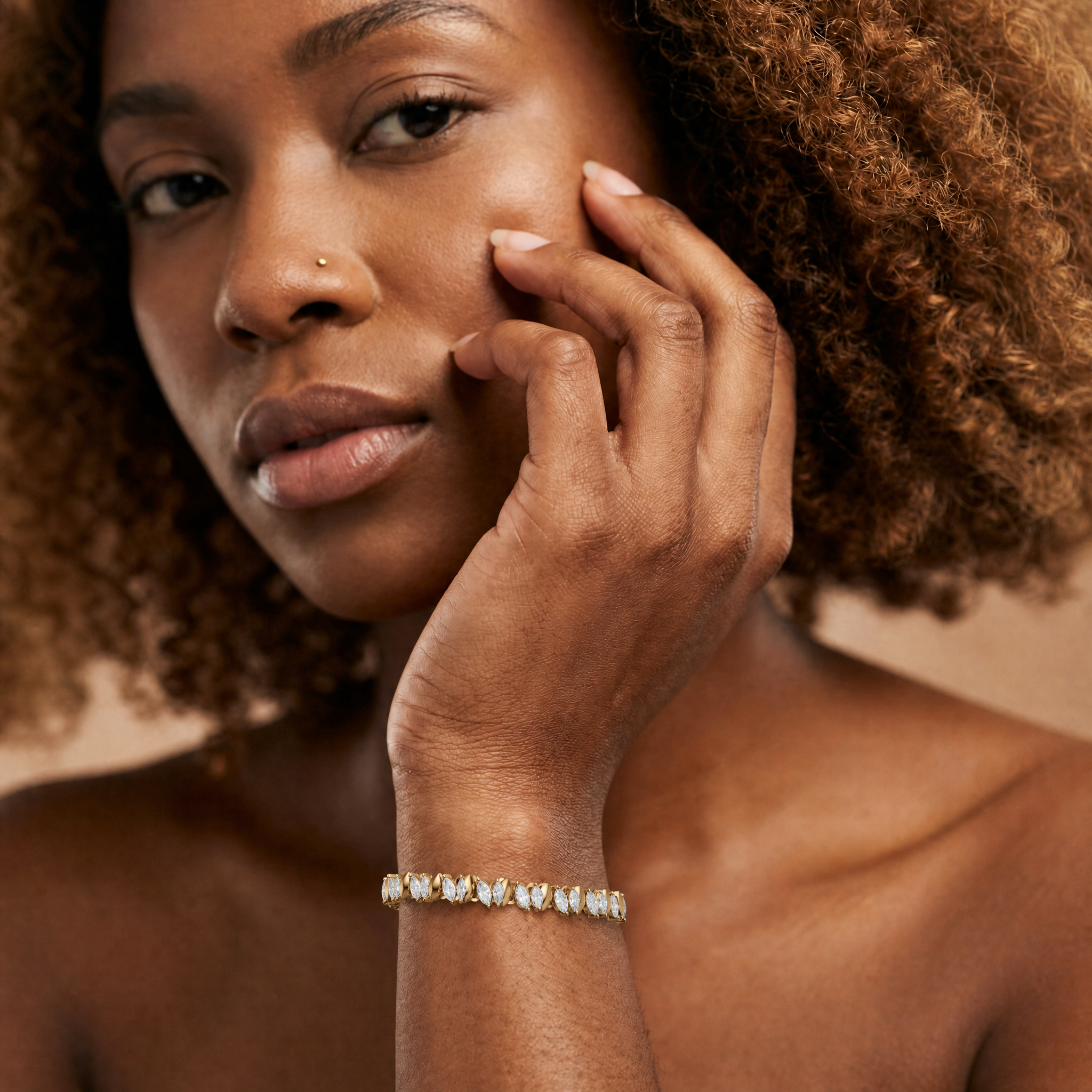 Elegant female model wearing a marquise cut lab grown diamond bracelet in yellow gold by Raul Diamonds featuring luxury fine jewelry craftsmanship with timeless modern elegance