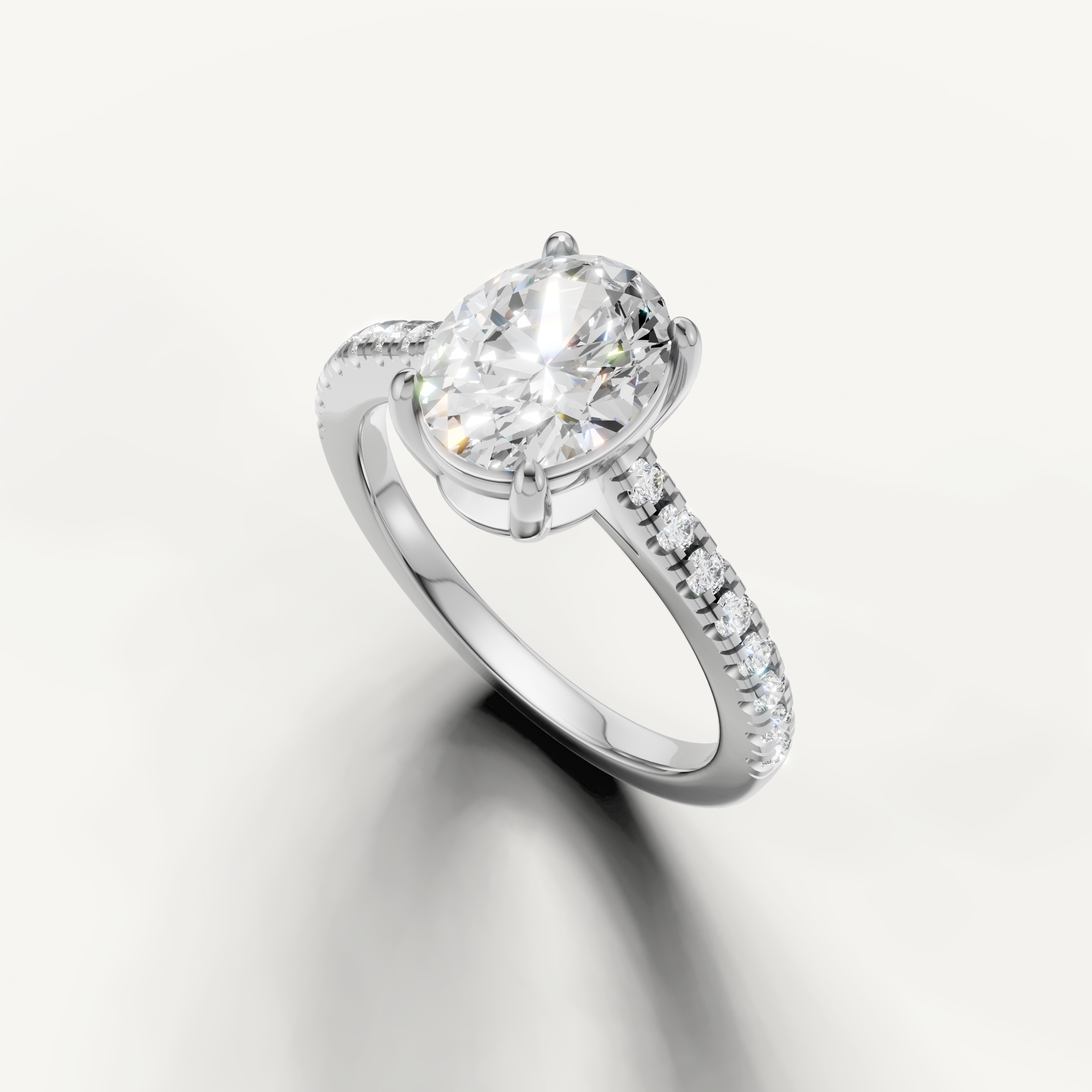 Minimal oval cut diamond ring in white gold with pavé band and brilliant finish