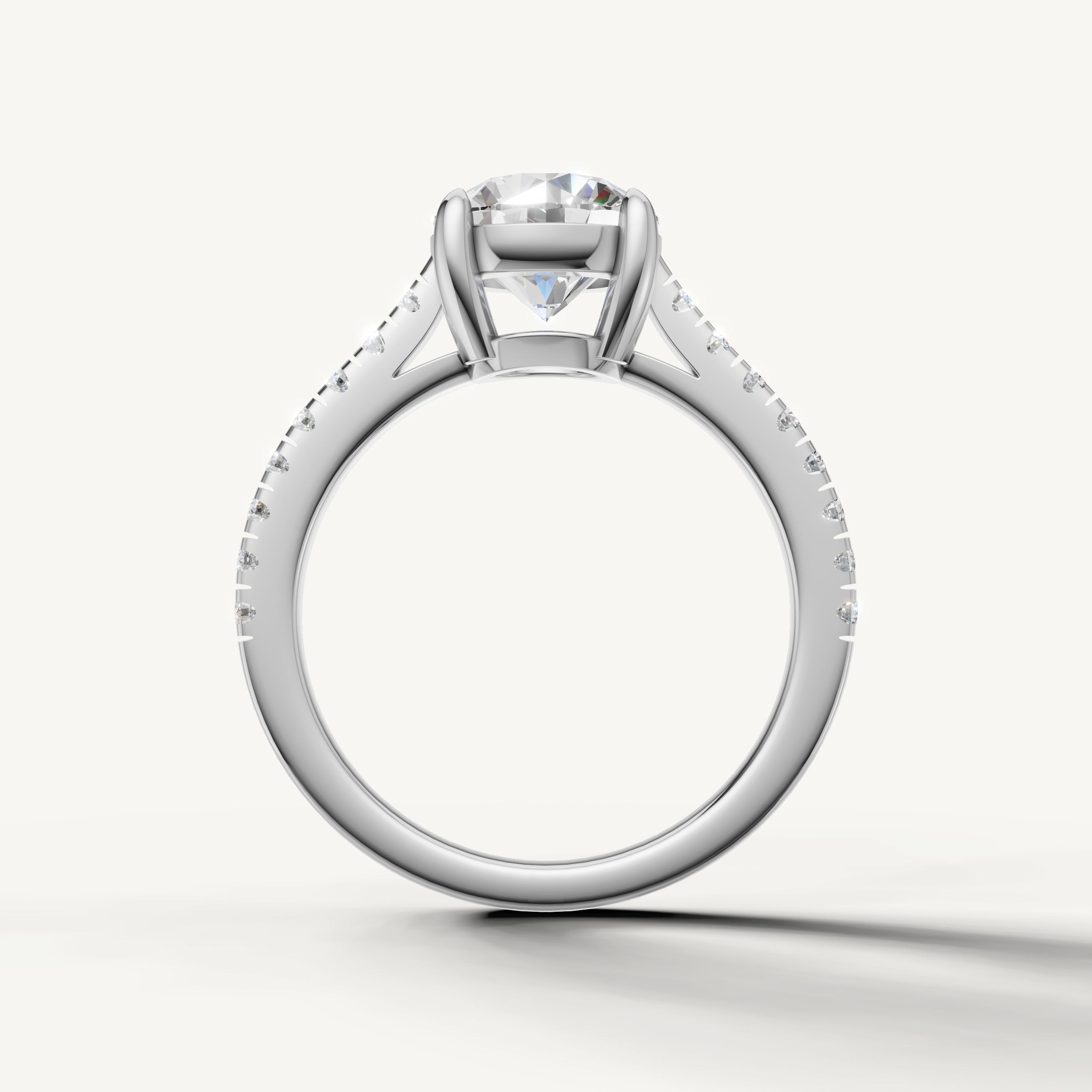 Classic round brilliant engagement ring in white gold with pavé diamonds