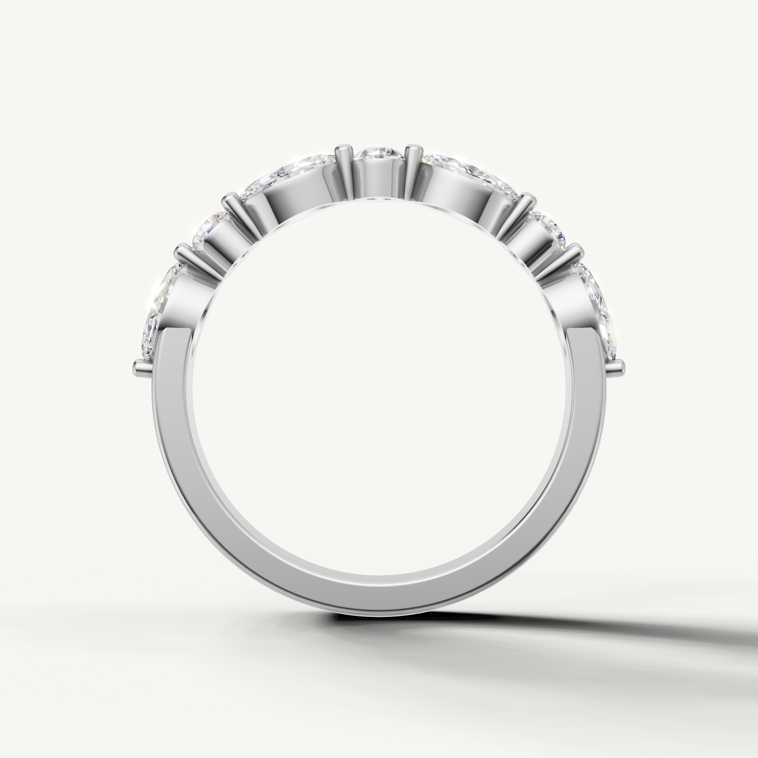 Fine white gold wedding band with sparkling pear and round diamonds from Raul Diamonds