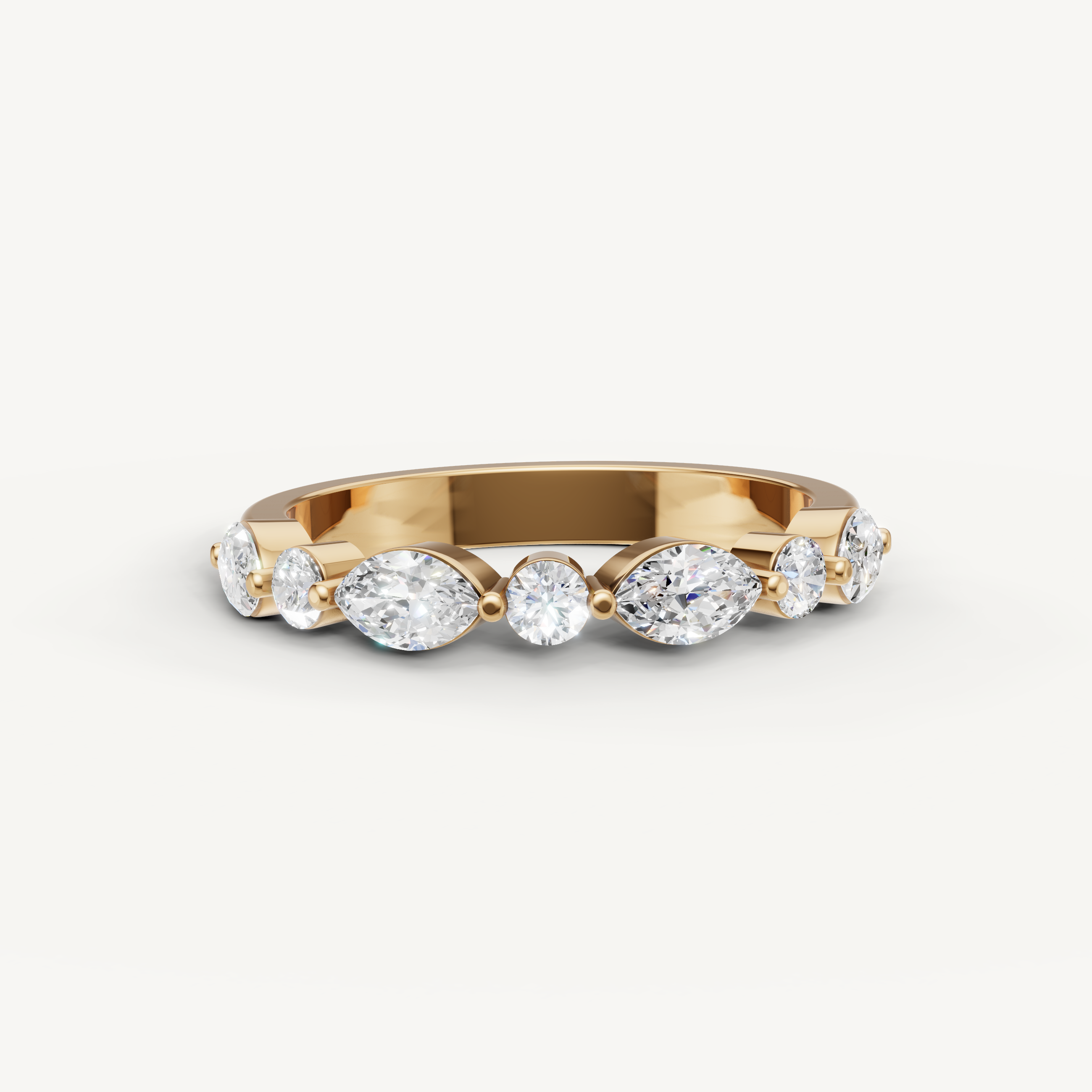 Raul Diamonds yellow gold wedding band with pear and round cut lab grown diamonds in a modern shared prong design