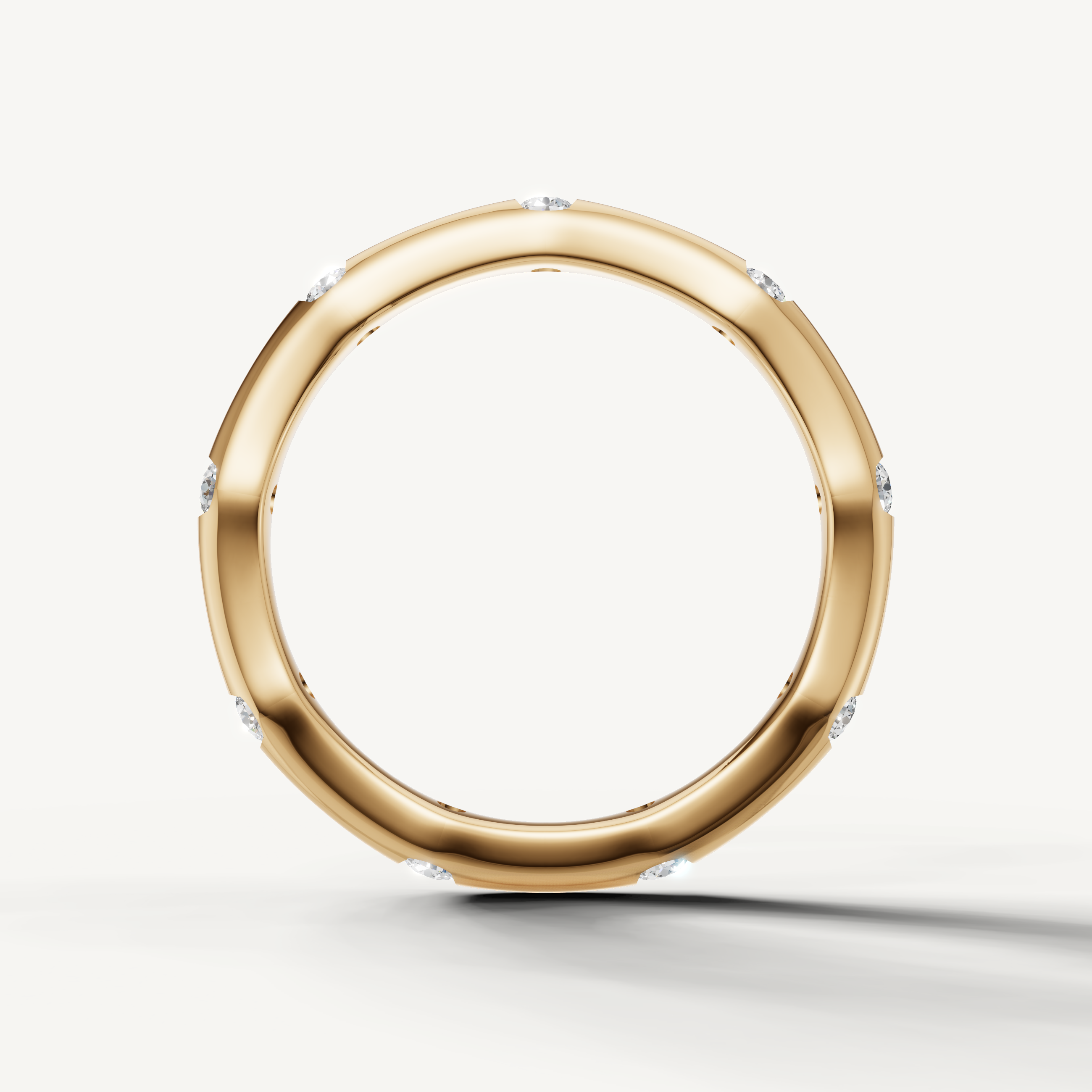 Modern yellow gold contour wedding band with brilliant bezel set diamonds crafted by Raul Diamonds