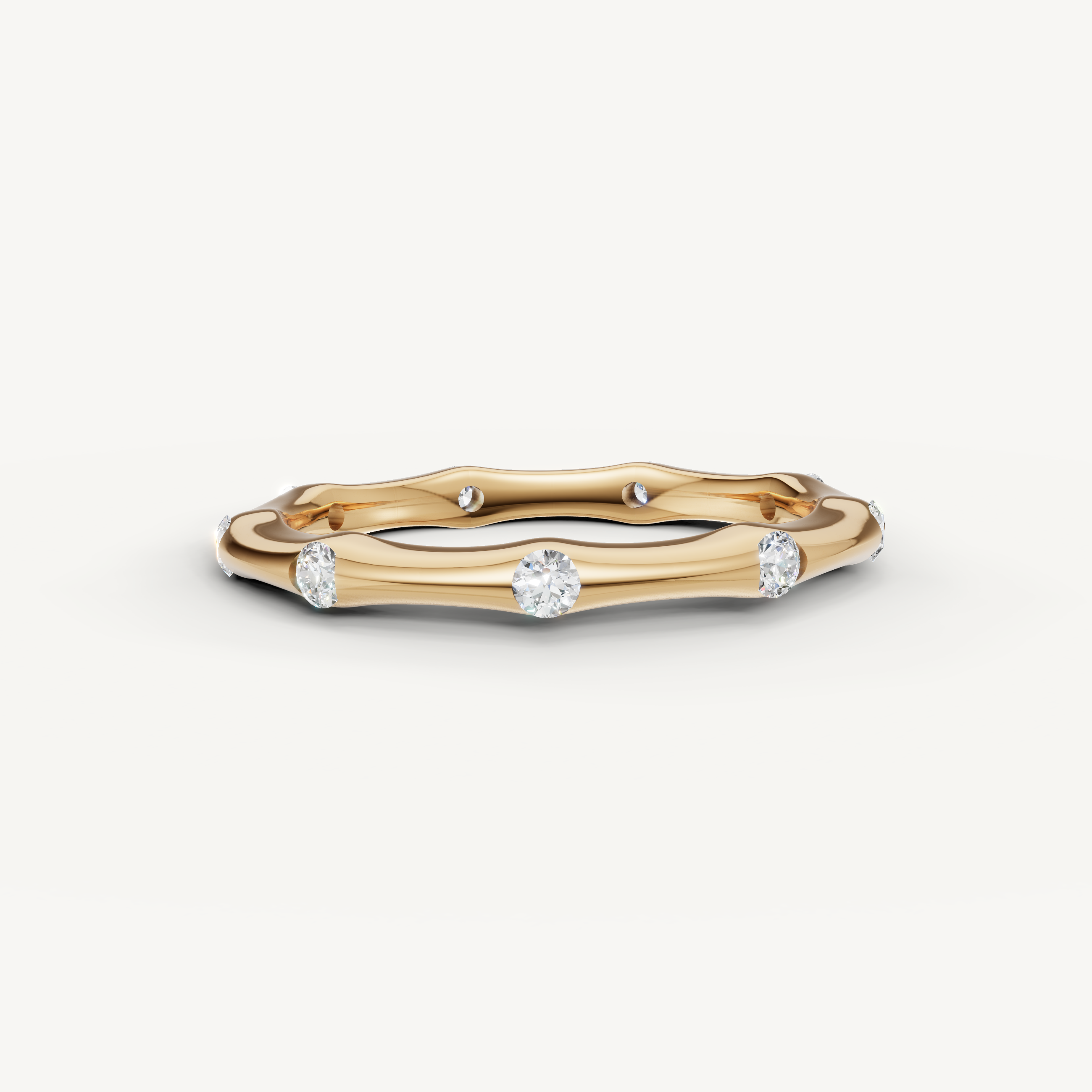 Raul Diamonds yellow gold curved diamond wedding band with bezel set round diamonds and modern minimalist design