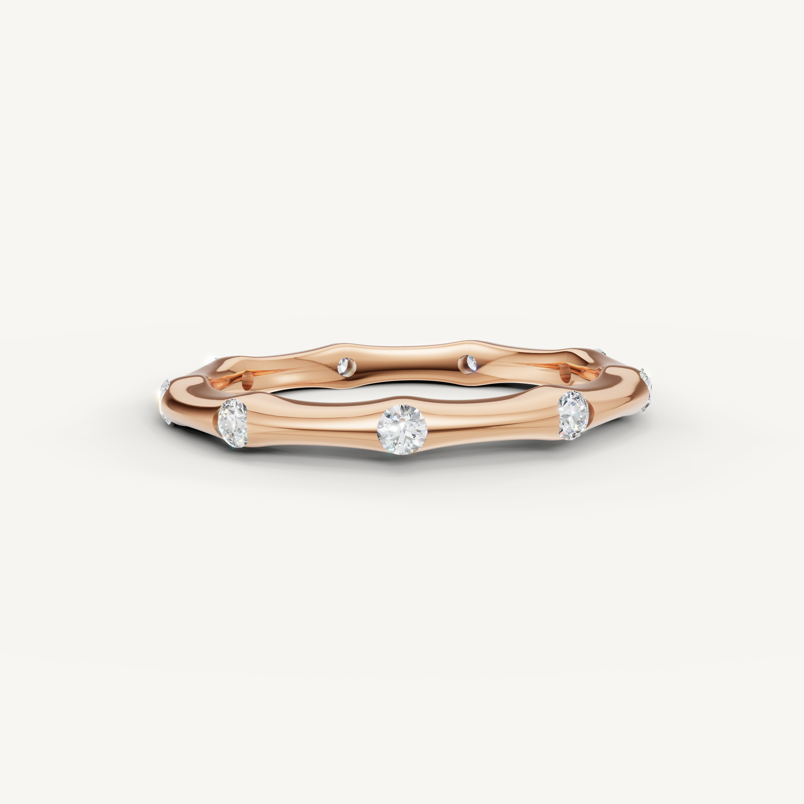 Raul Diamonds rose gold curved diamond wedding band with bezel set round diamonds and elegant wave styling