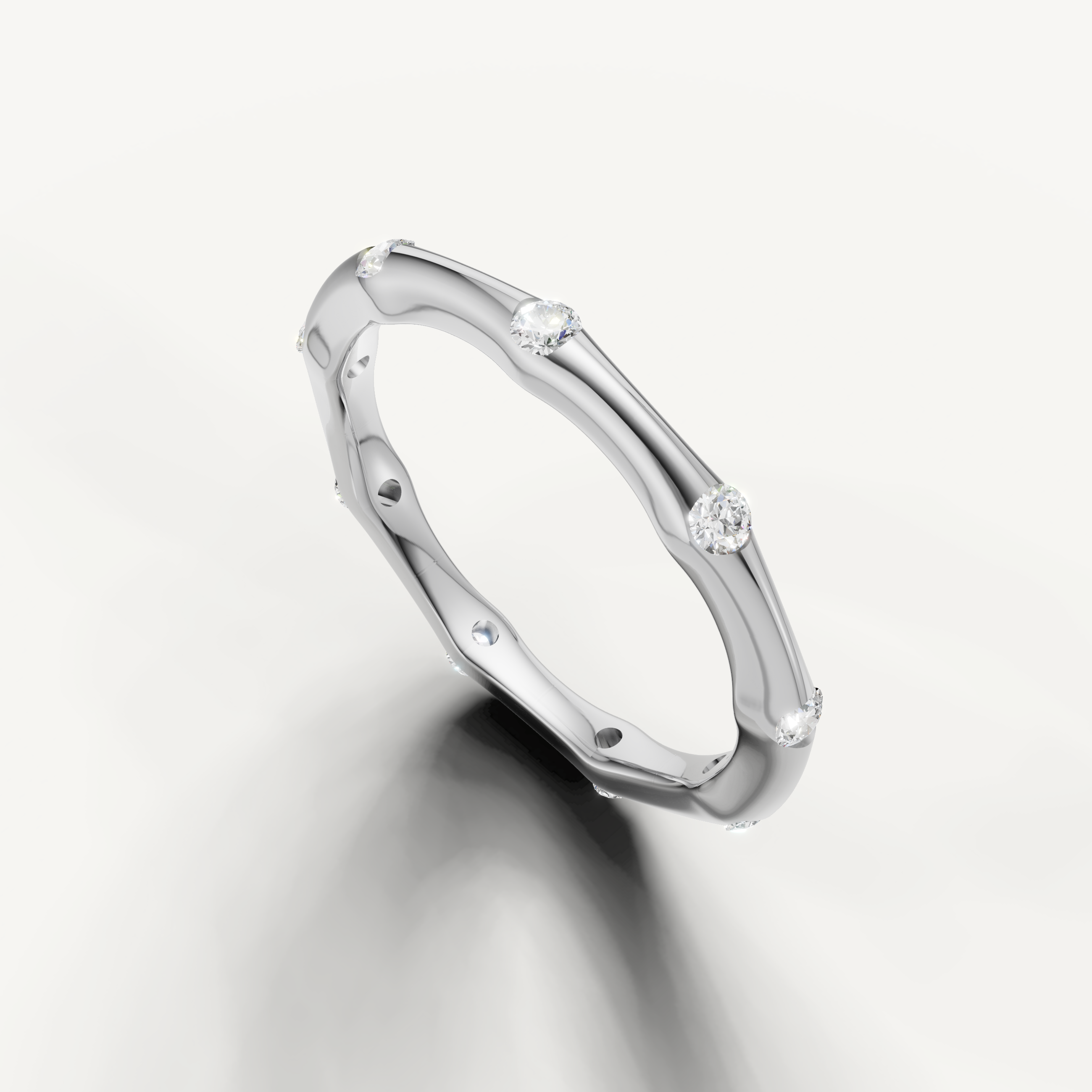 Luxury white gold diamond wedding band with spaced round diamonds and contemporary curved silhouette from Raul Diamonds
