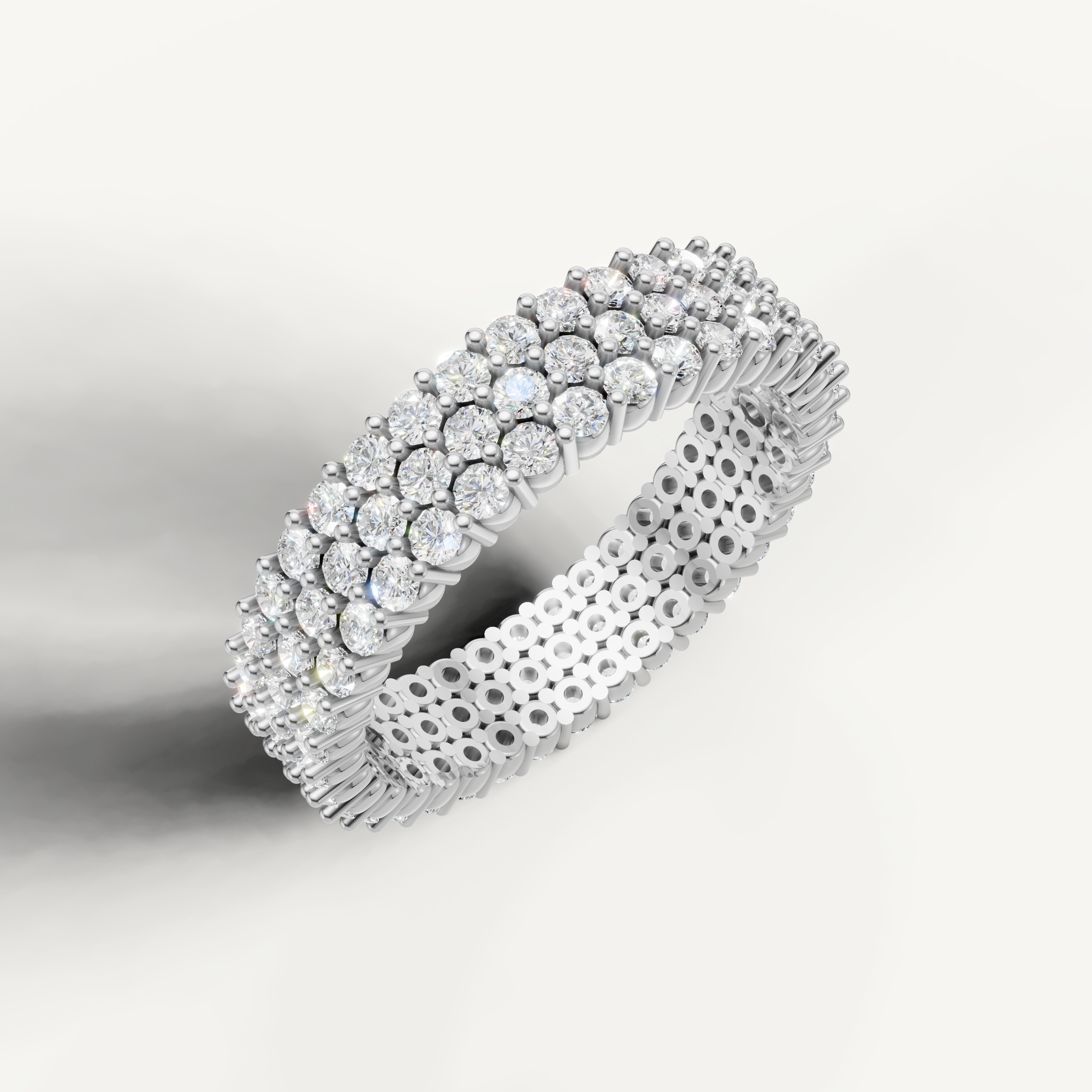 Elegant white gold diamond eternity wedding ring featuring triple row pavé diamonds by Raul Diamonds
