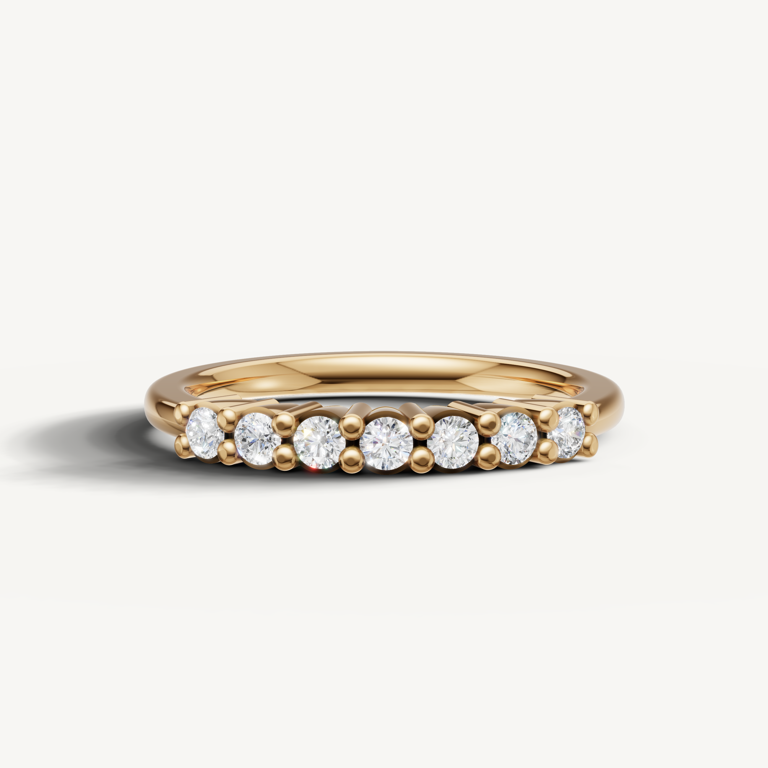Raul Diamonds yellow gold diamond wedding band with round brilliant shared prong diamonds