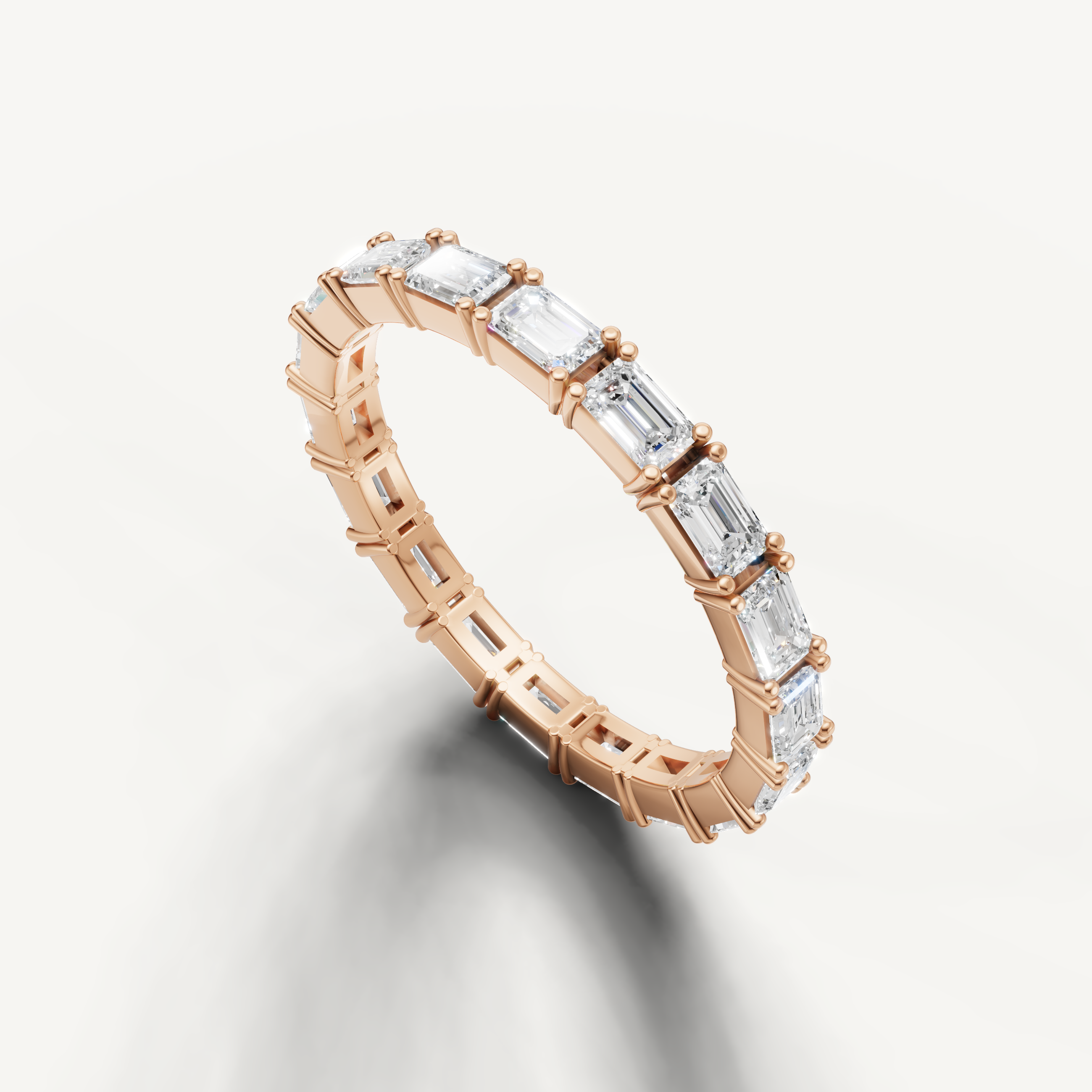 Rose gold eternity wedding band with emerald cut diamonds by Raul Diamonds