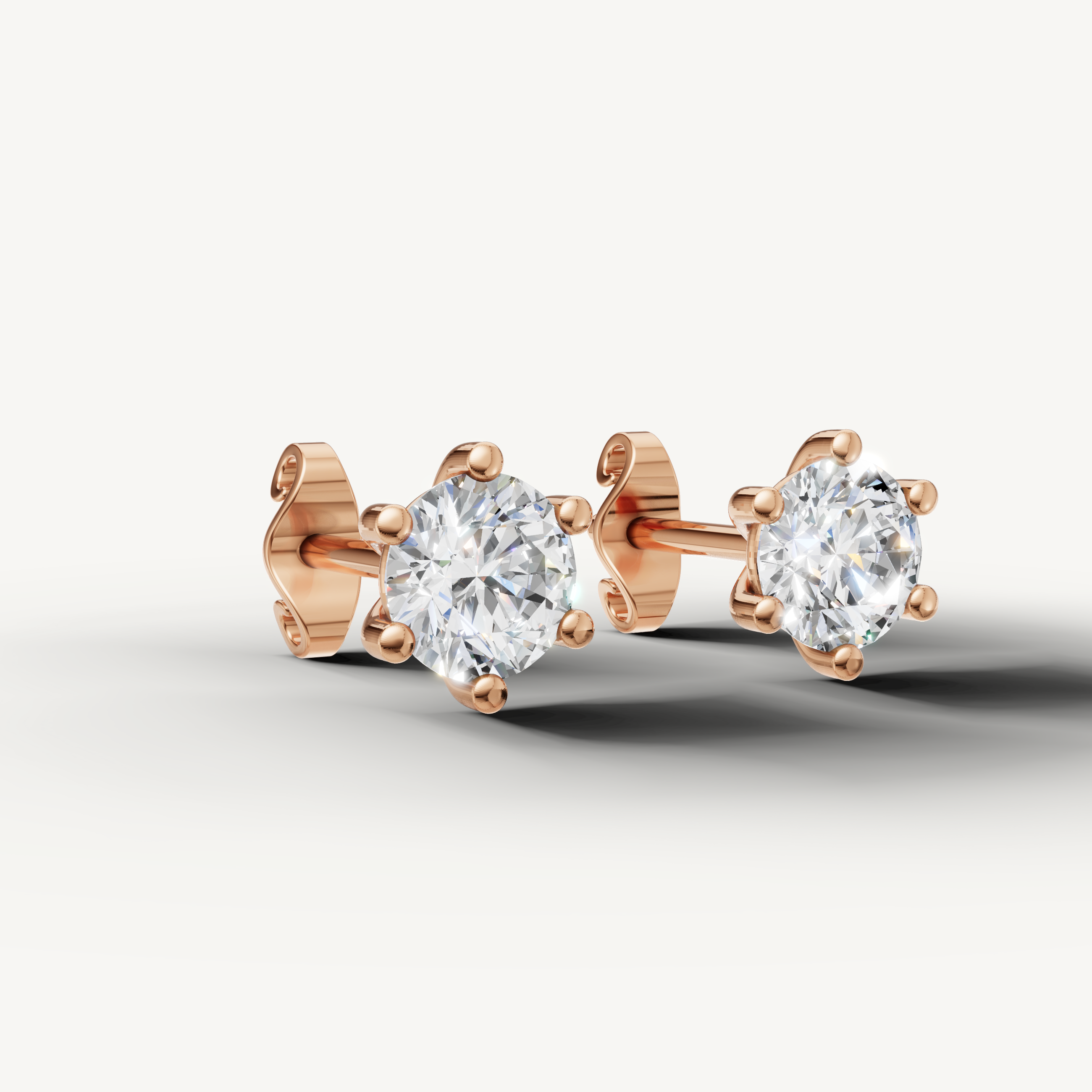 Rose gold solitaire diamond earrings by Raul Diamonds featuring sparkling round brilliant diamonds