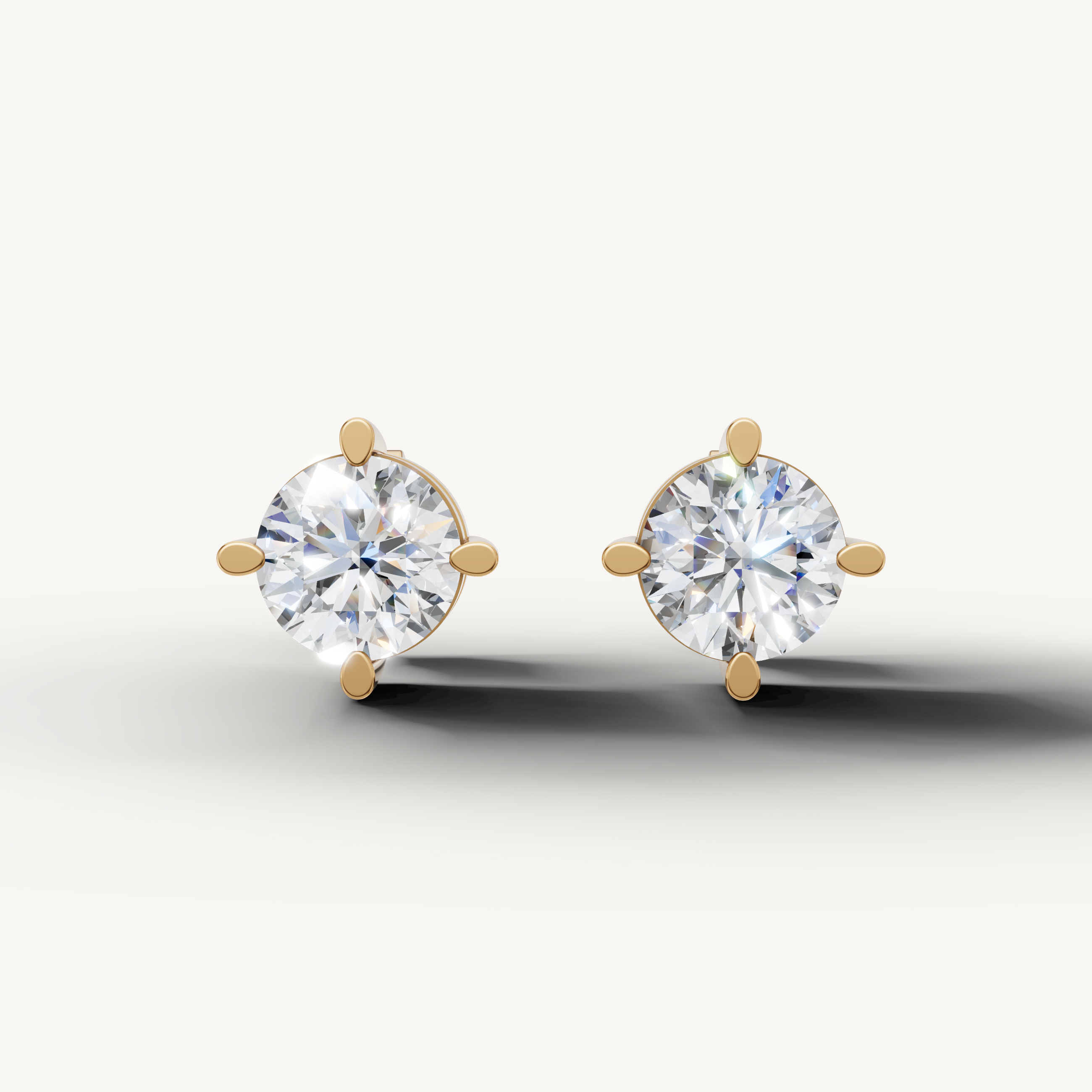 Raul Diamonds yellow gold round diamond stud earrings with elegant four prong solitaire setting