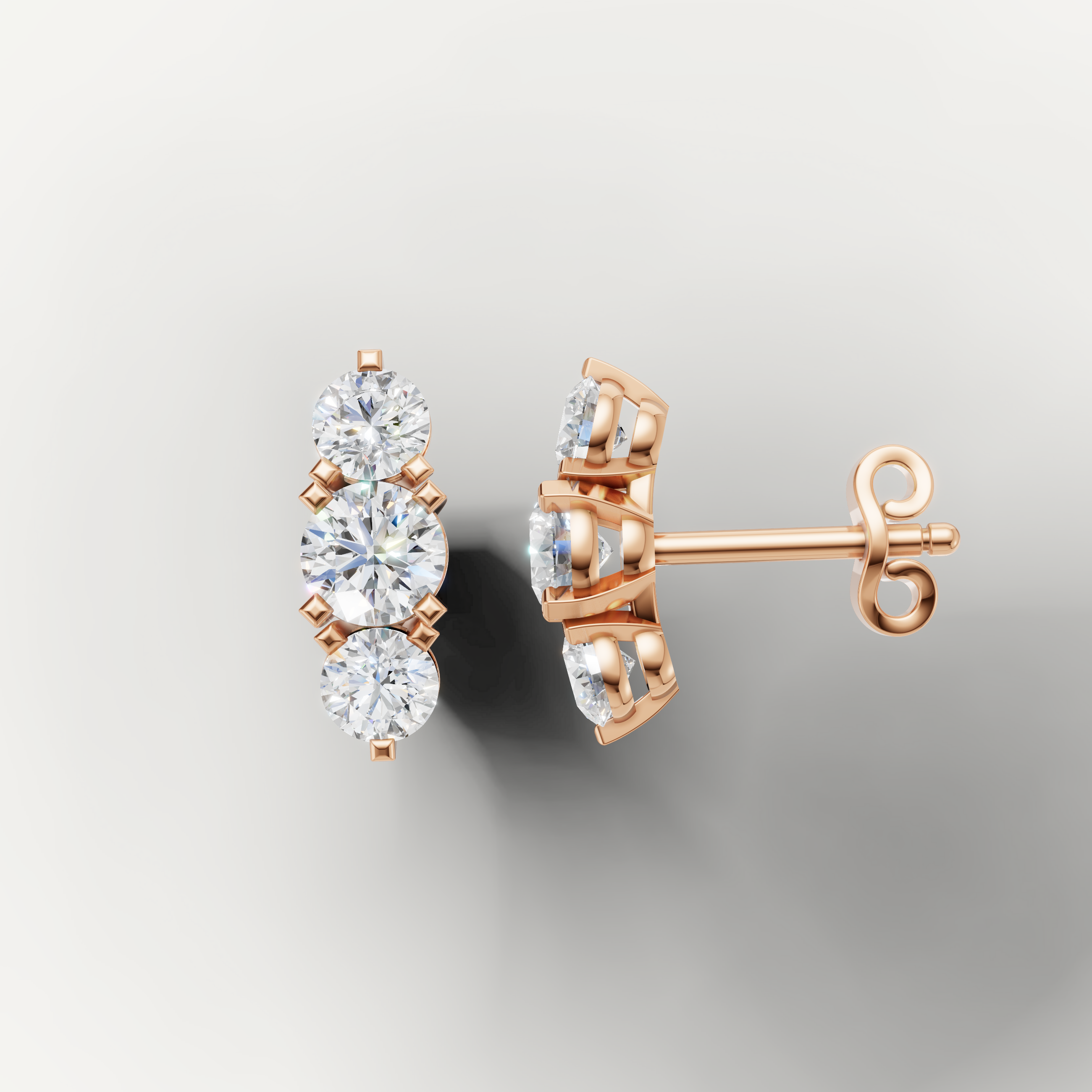 Rose gold three stone diamond earrings by Raul Diamonds with elegant sparkle