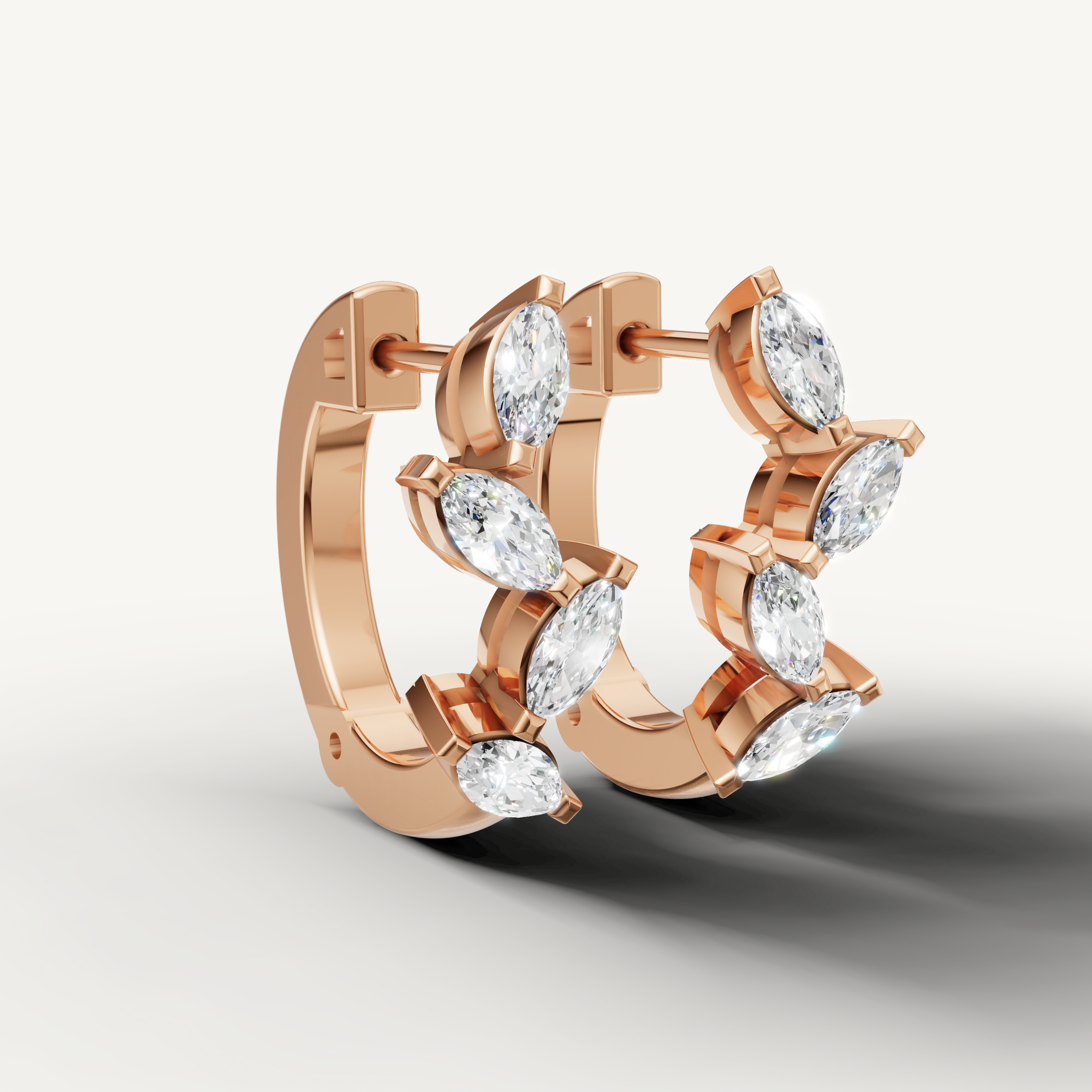 Rose gold marquise cut diamond earrings by Raul Diamonds with elegant leaf motif